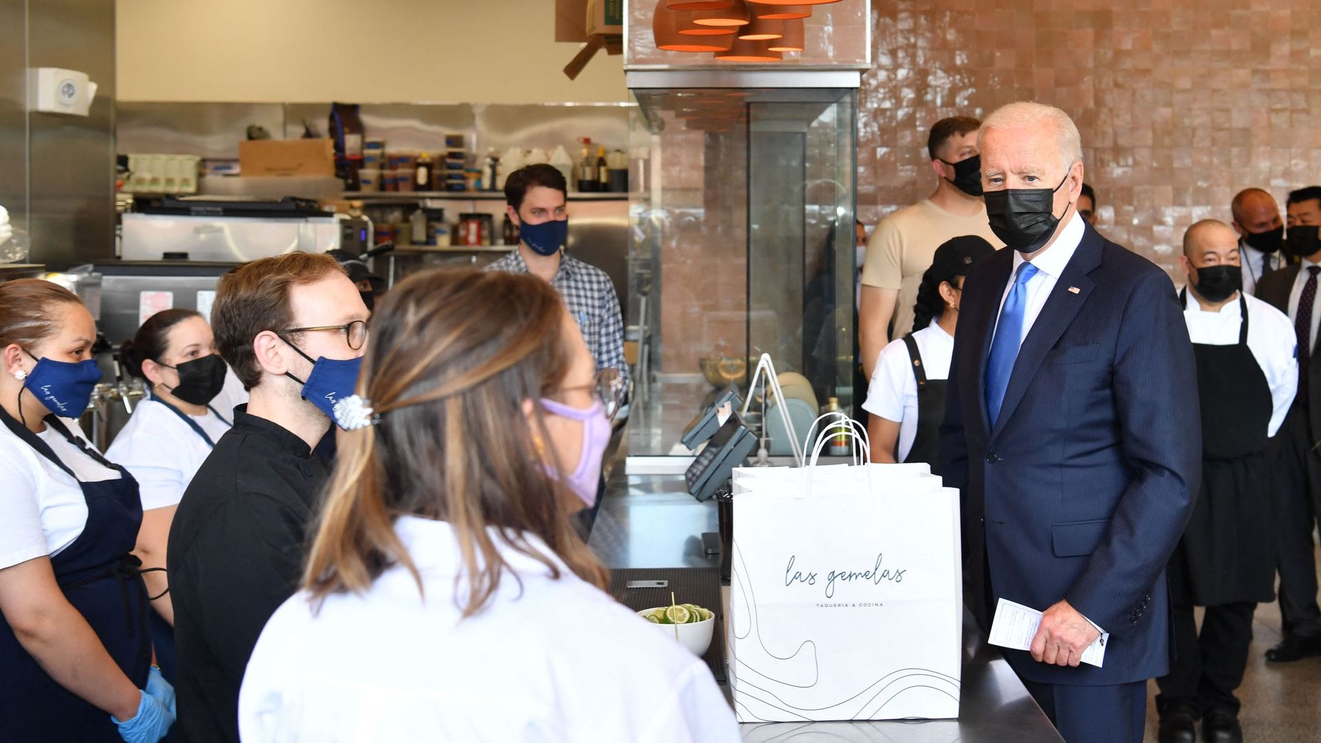 President Biden surrounded by workers at Las Gemelas Taqueria in 2021.