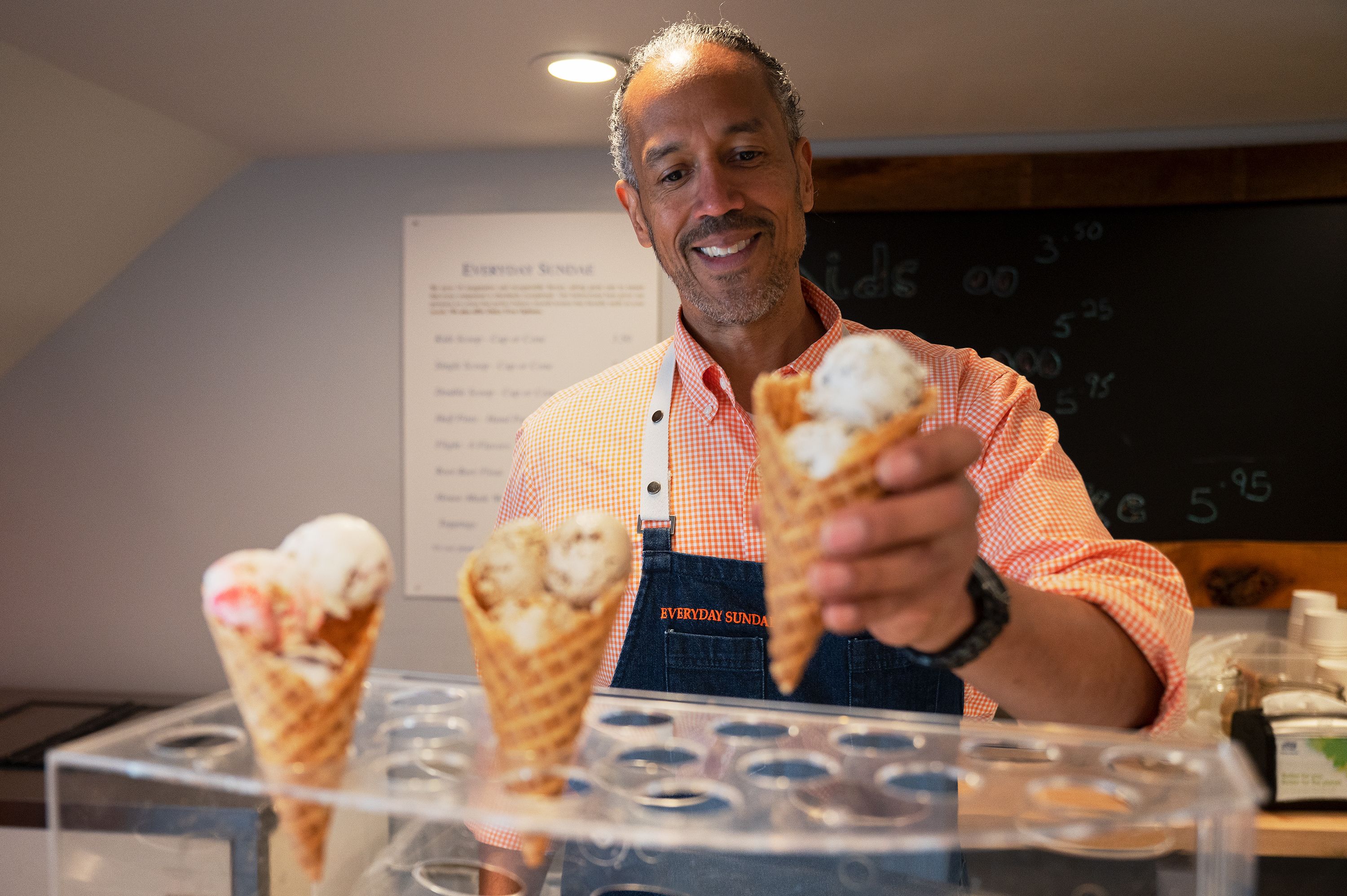Everyday Sundae owner Charles Foreman serves ice cream cones 