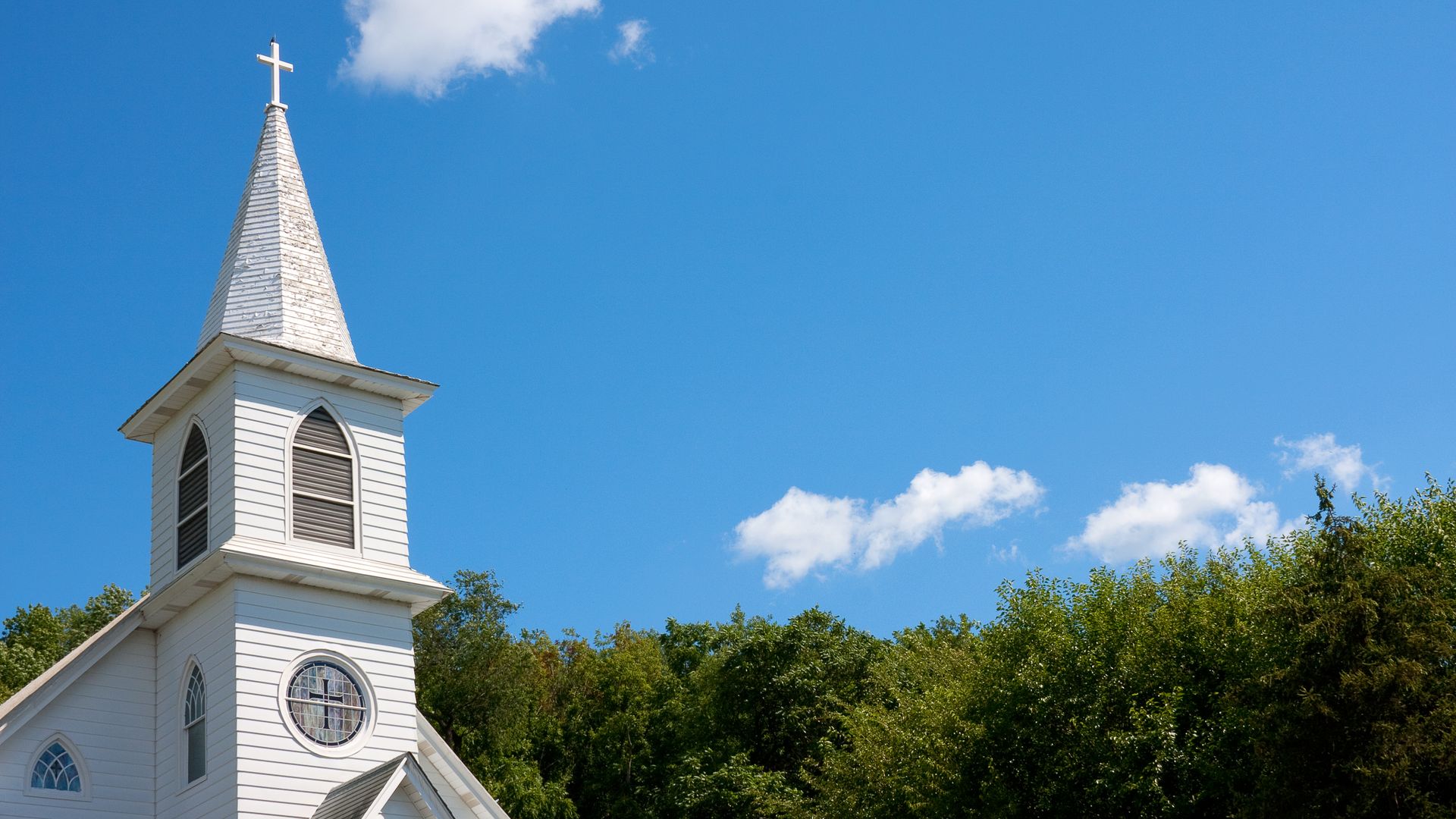 This is an image of a white church against a blue sky.