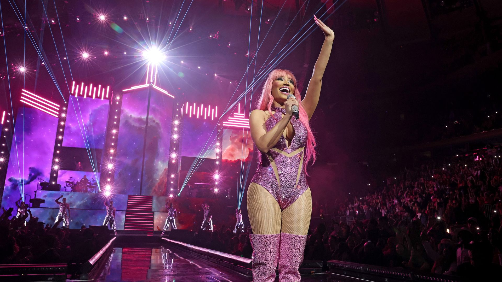 Nicki Minaj waves to a crowd during one of her concerts. 