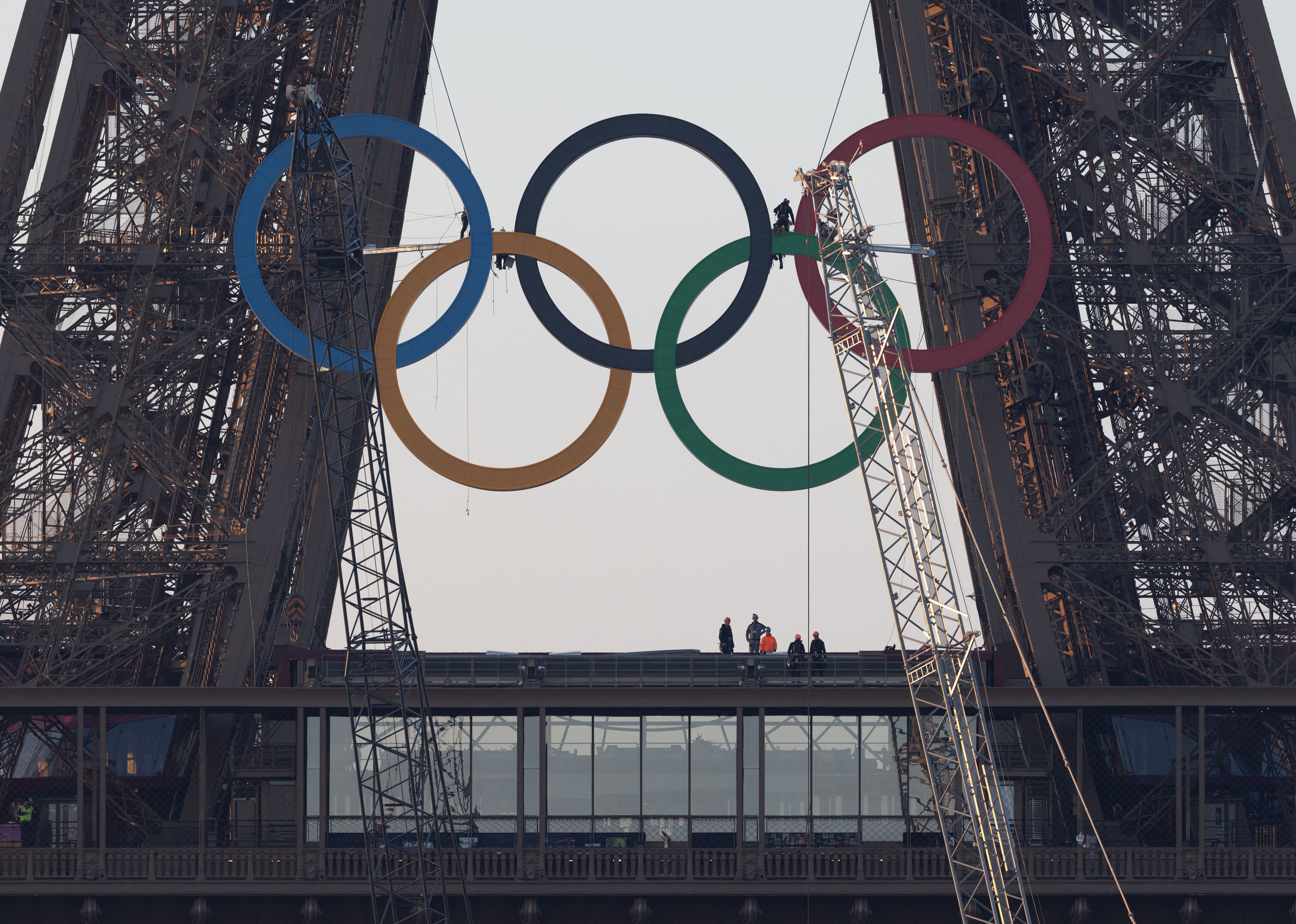 TOPSHOT - The Olympic rings are seen on the Eiffel Tower before an unveiling ceremony in Paris, early on June 7, 2024, ahead the upcoming Paris 2024 Olympic Games