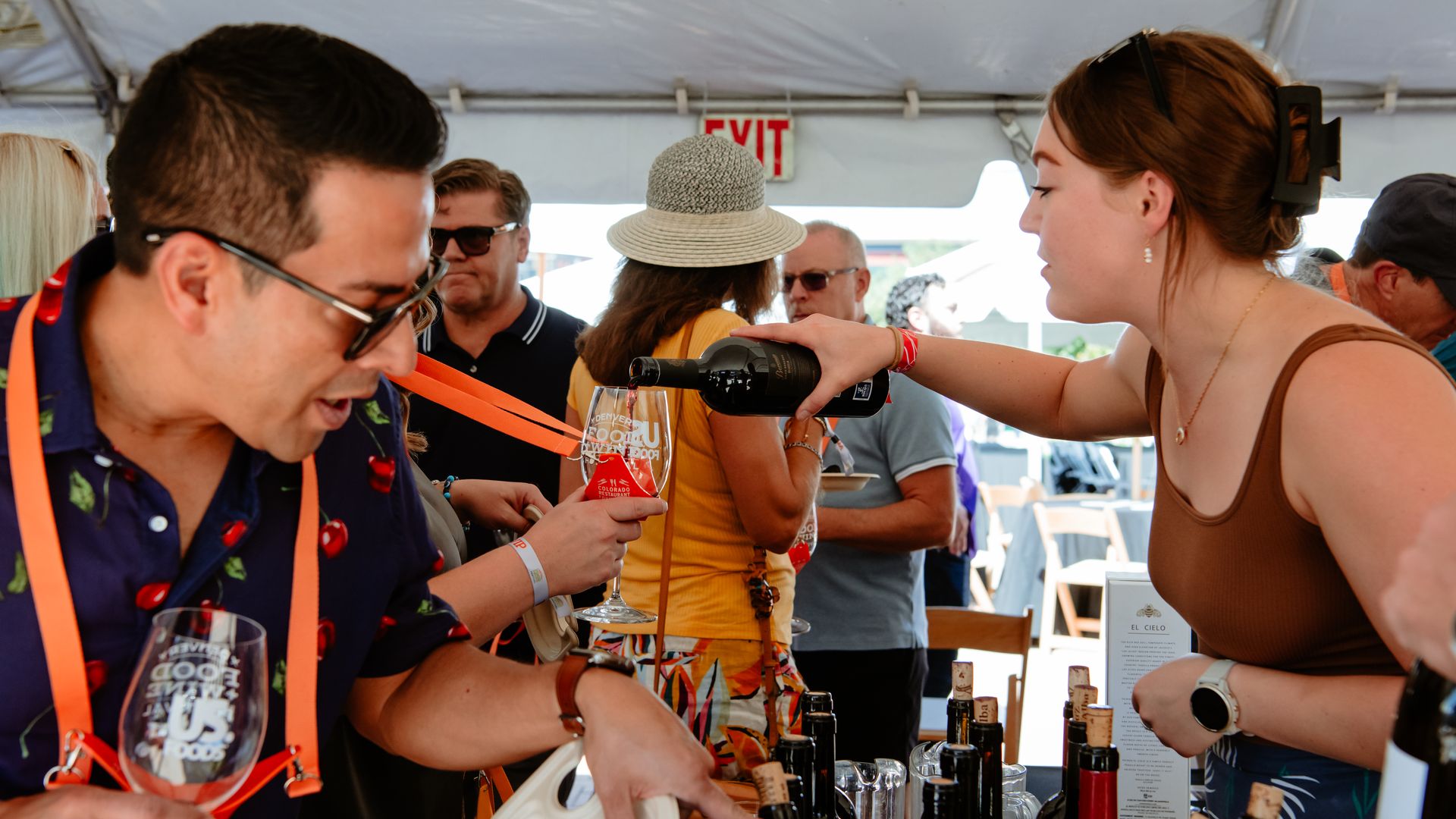 Woman pouring a glass of wine at the Dever food and wine festival