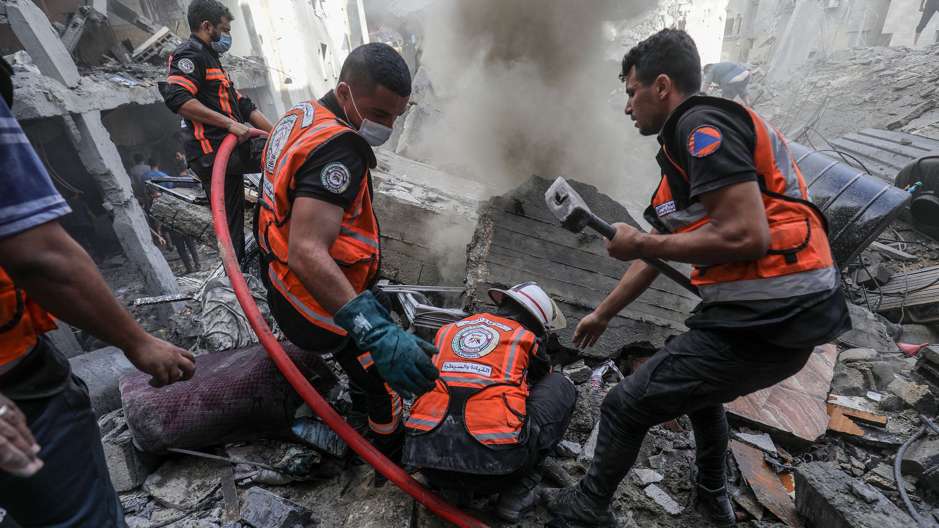 Civil defense teams and residents launch a search and rescue operation around the buildings that were destroyed after Israel's attacks on the Gaza Strip