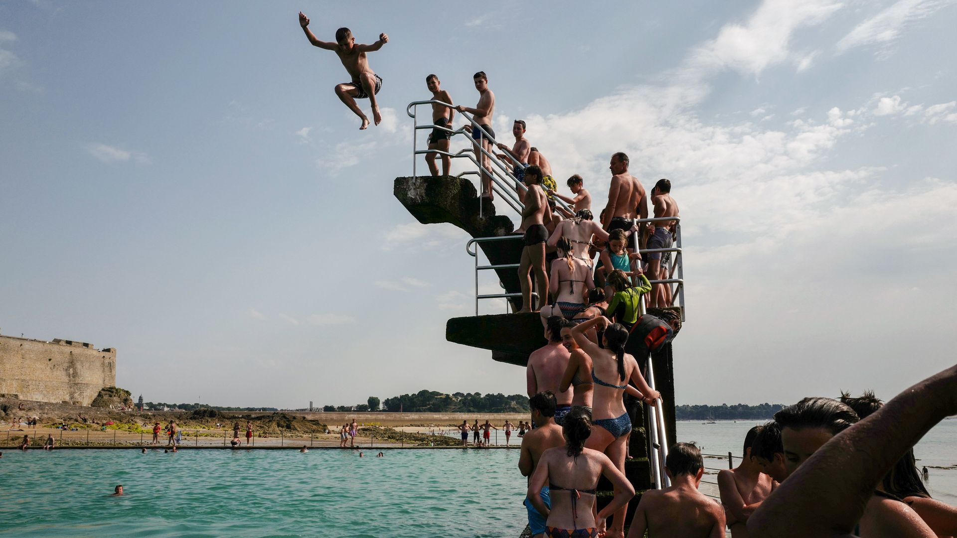 People queue to dive into the landmark sea pool of Saint-Malo, Brittany.