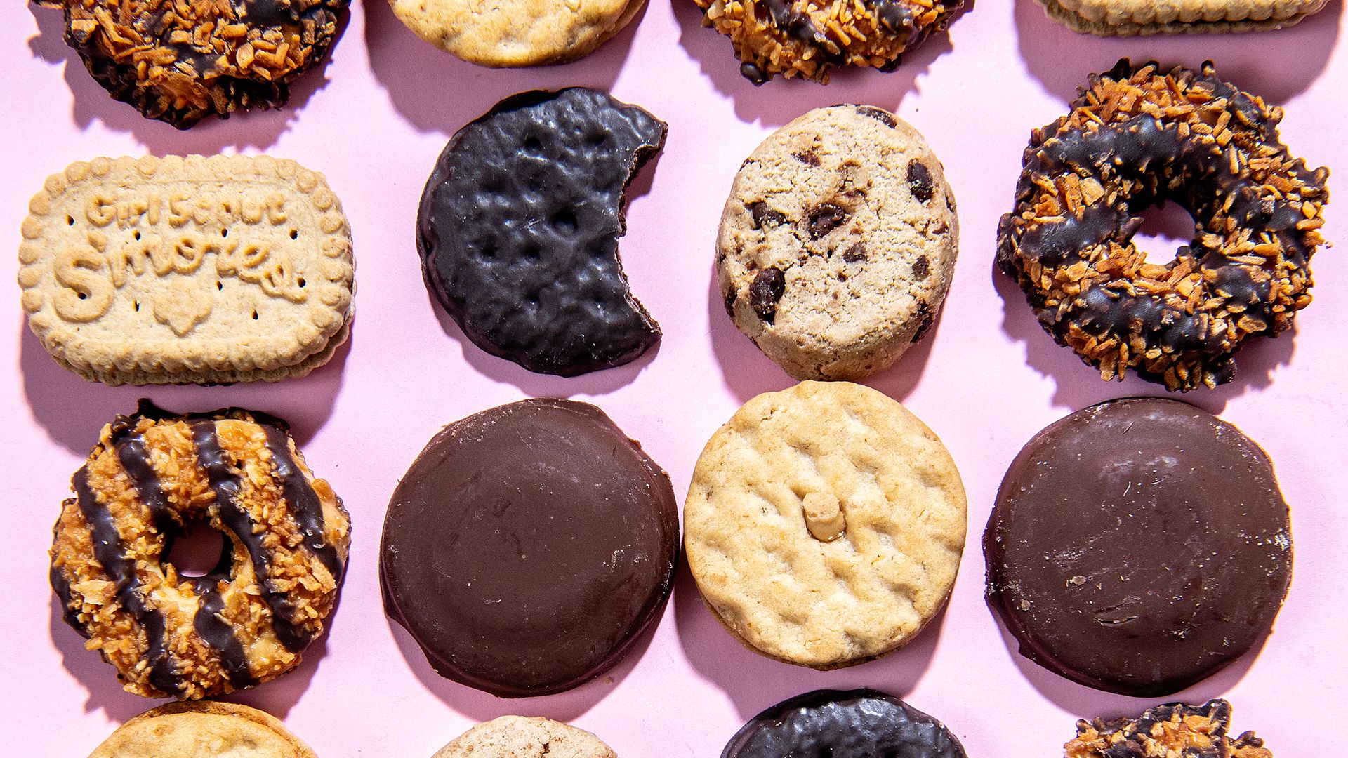 an array of girl scout cookies on a pink background