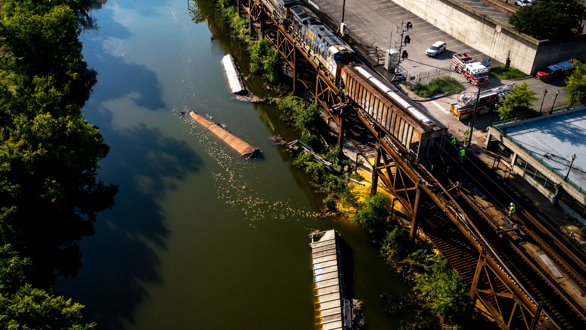 an aerial view of a train derailed into the james river