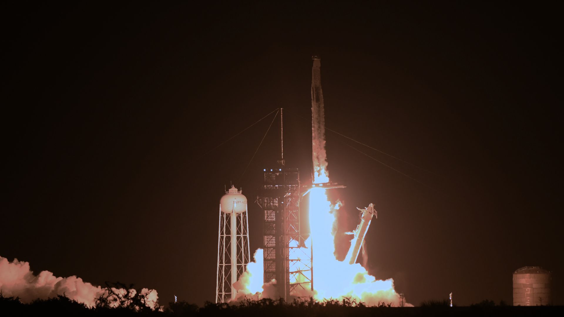 A SpaceX Falcon 9 rocket with the Crew Dragon spacecraft launches from pad 39A at the Kennedy Space Center.