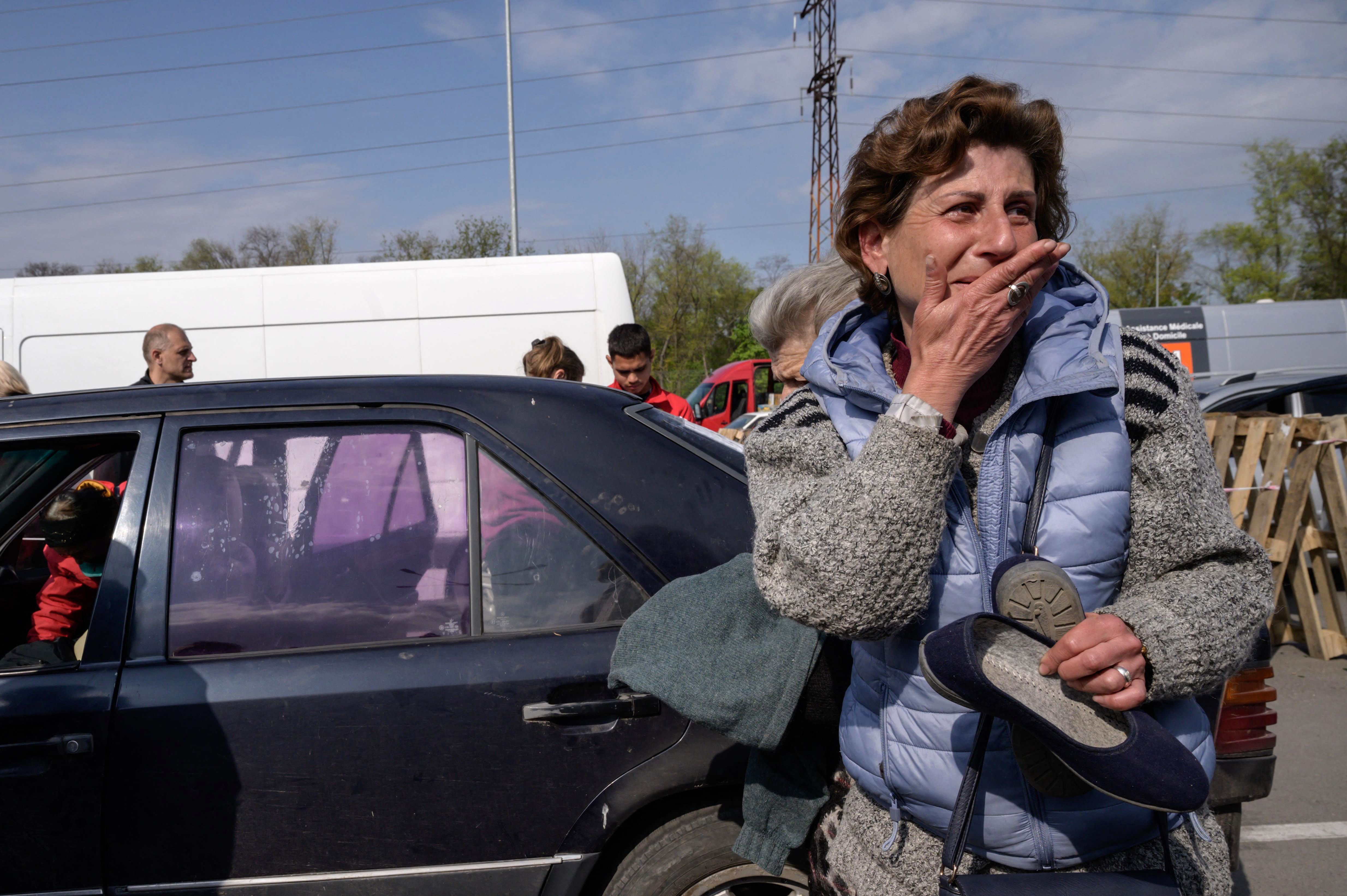 Natasha from Mariupol reacts as she arrives in her own vehicle at a registration and processing area in Zaporizhzhia