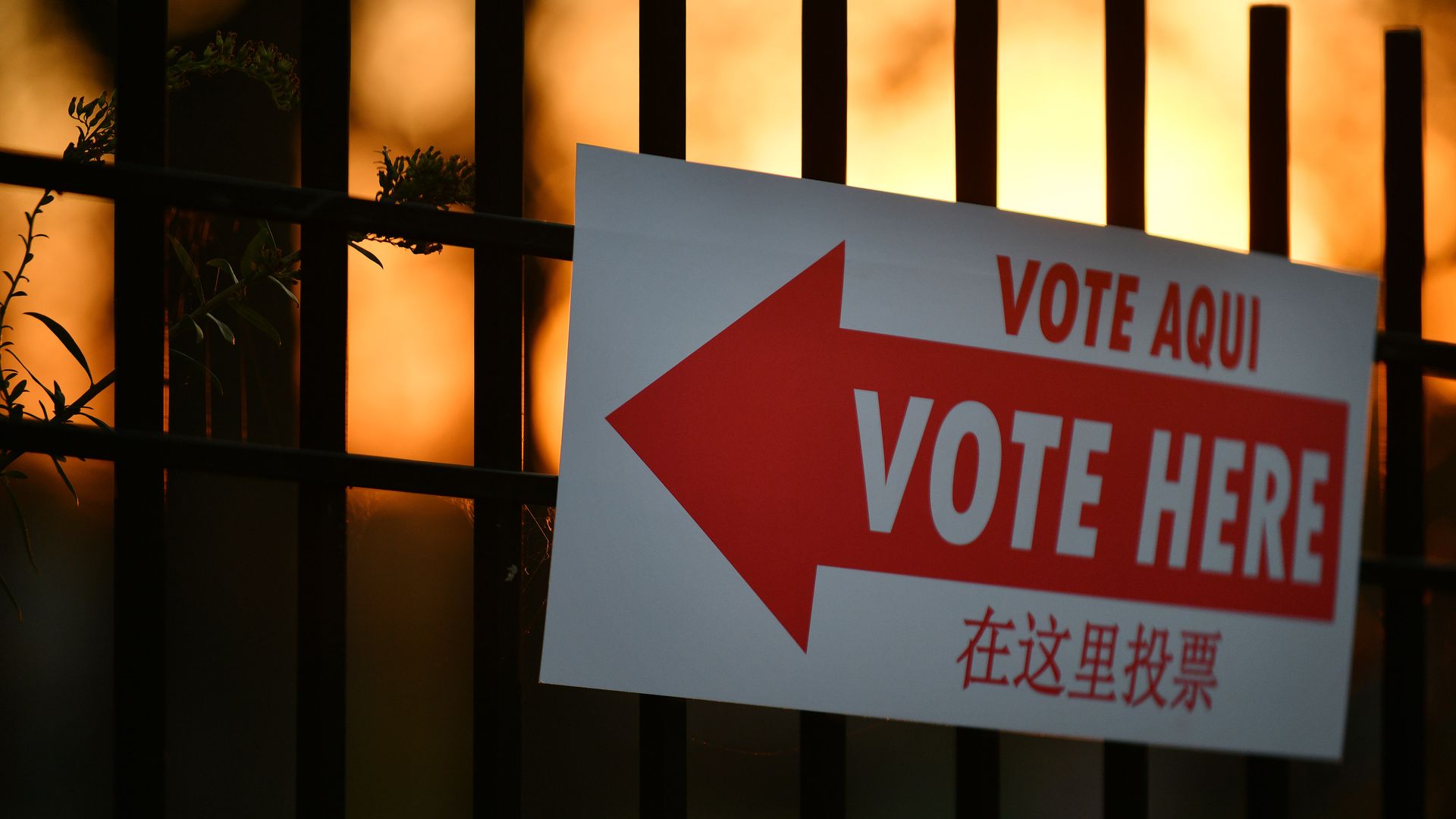 A sign that says Vote Here with an arrow.