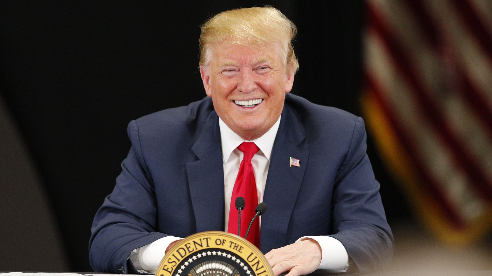 President Donald Trump speaking at a podium