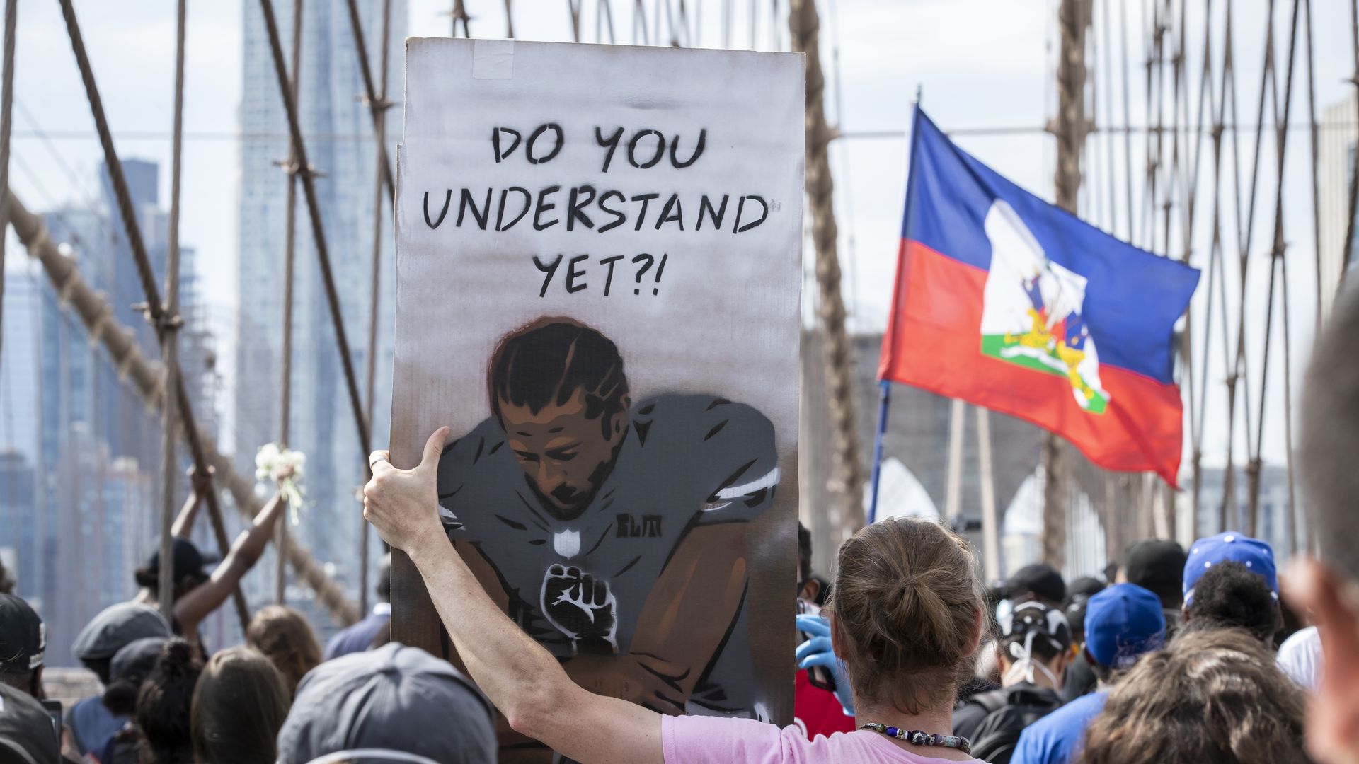 Protesters carrying Kaepernick sign