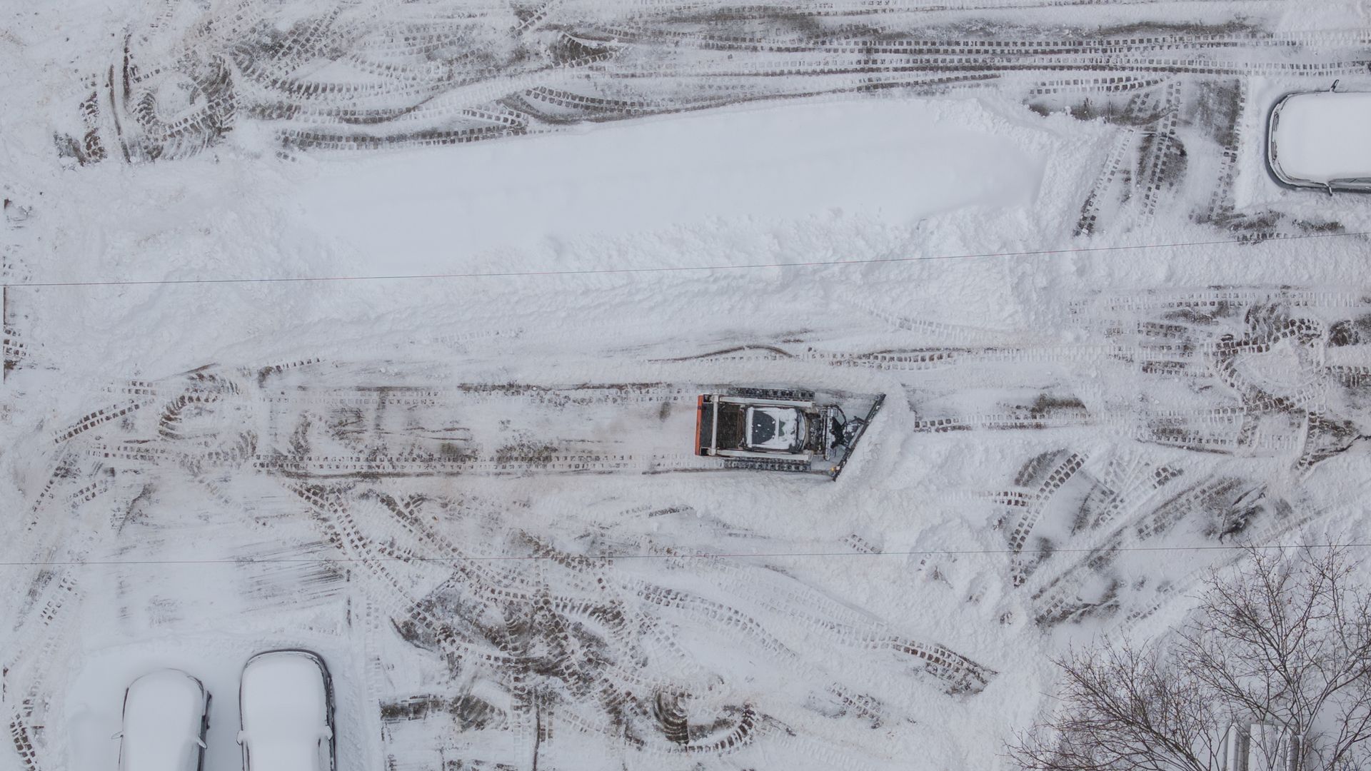 A snow plow clears a parking lot in Sharpsburg, Pennsylvania, US, on Monday, Jan. 26, 2026.