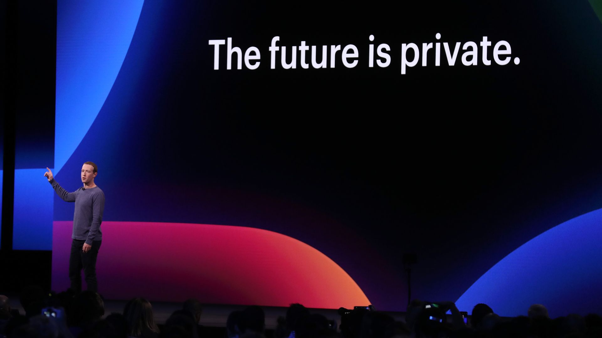 Photo of Facebook CEO Mark Zuckerberg onstage with a slide reading "The future is private"