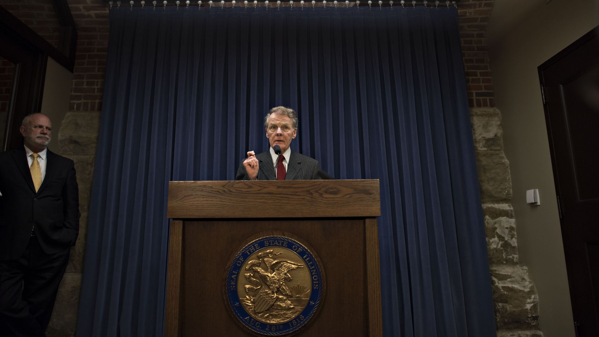 Politician at a podium.