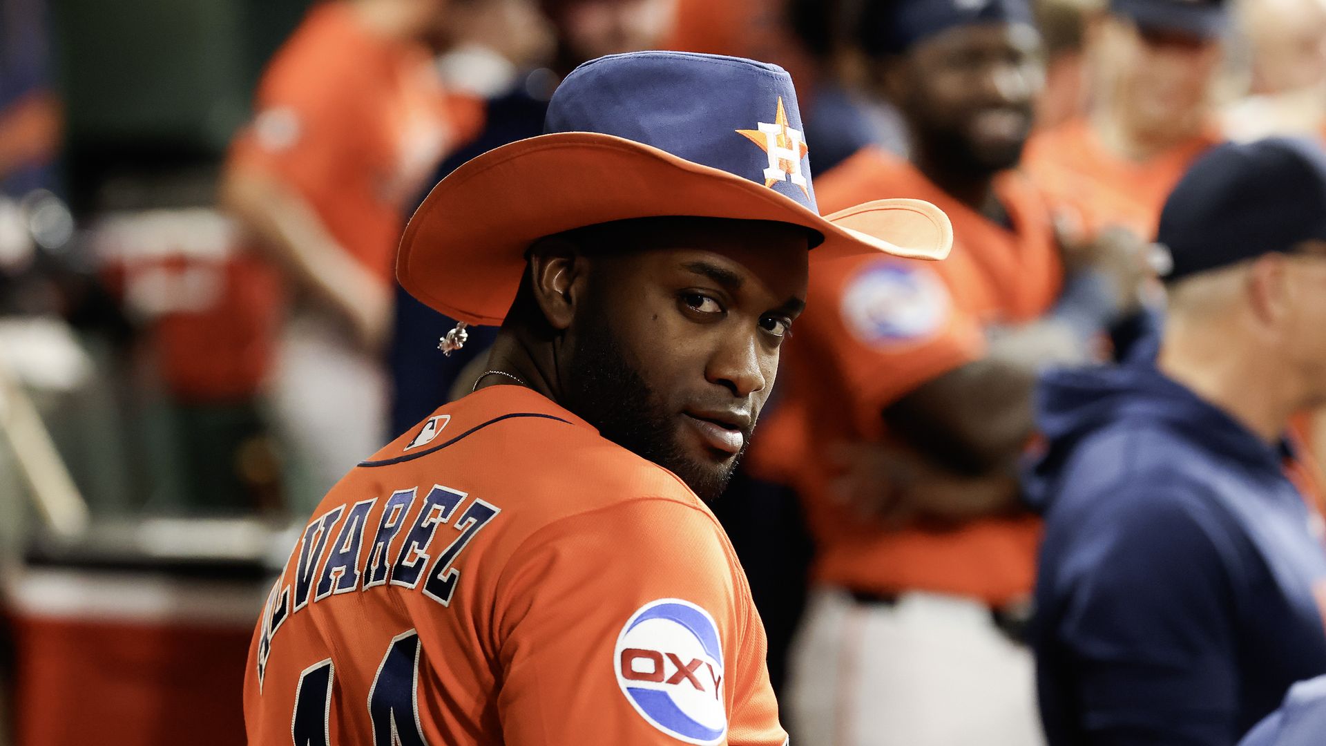 Astros outfielder Yordan Alvarez looks back at the camera as he dons a special Astros cowboy hat to celebrate hitting a home run