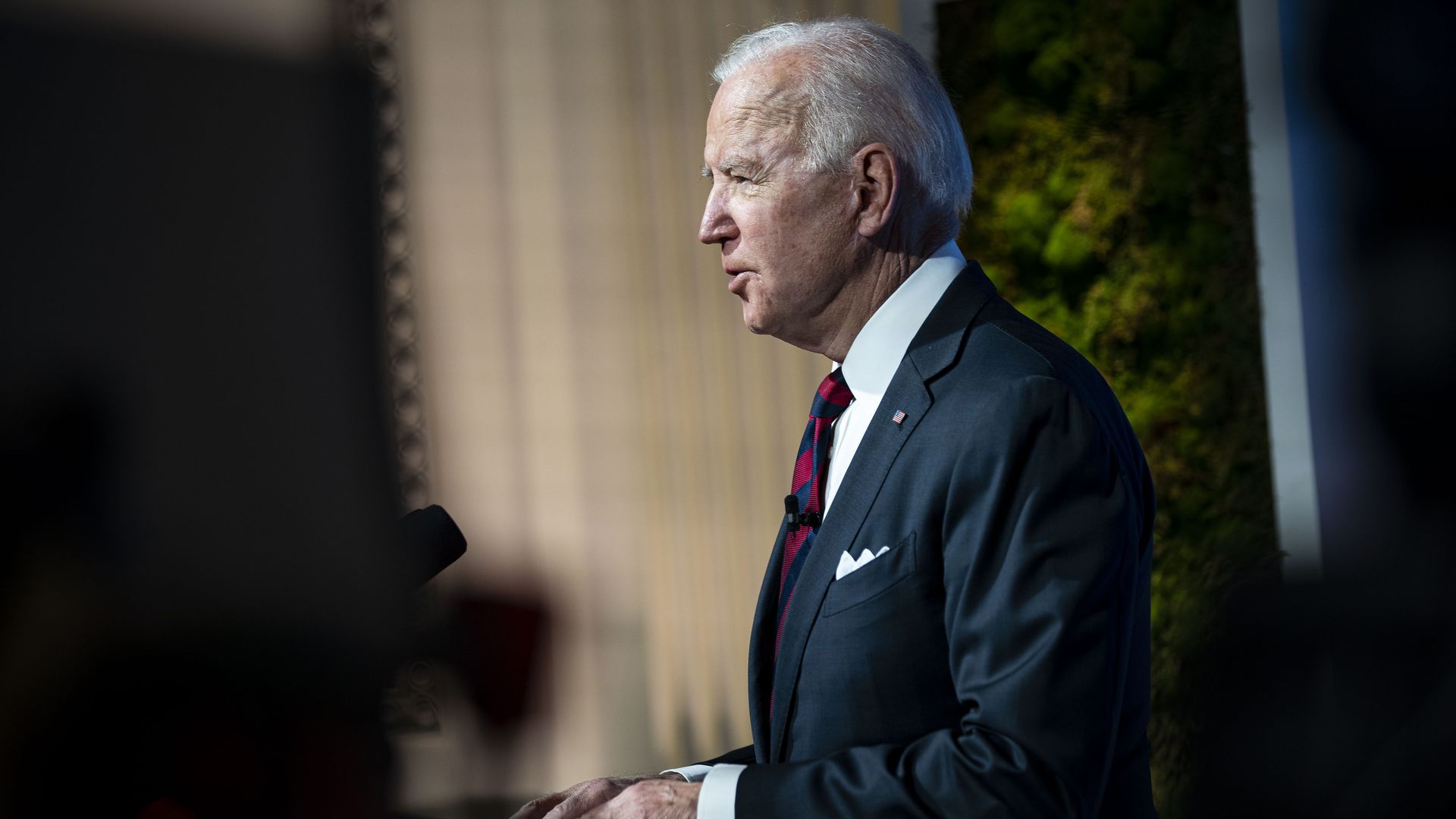 Profile view of President Biden delivering remarks