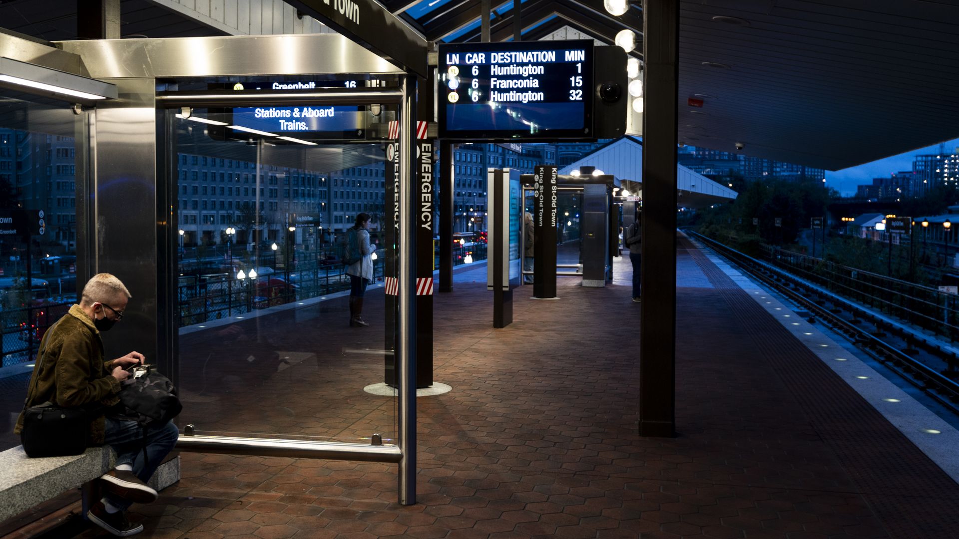A commuter waits for the Metro.