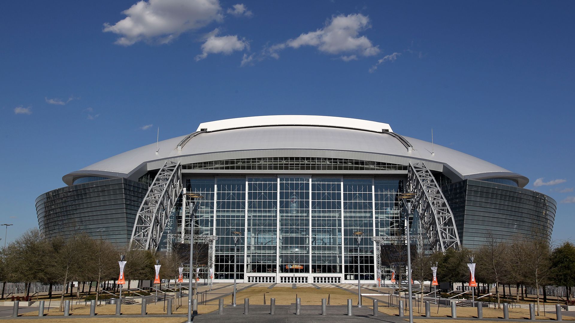A giant stadium in front of a bright blue sky
