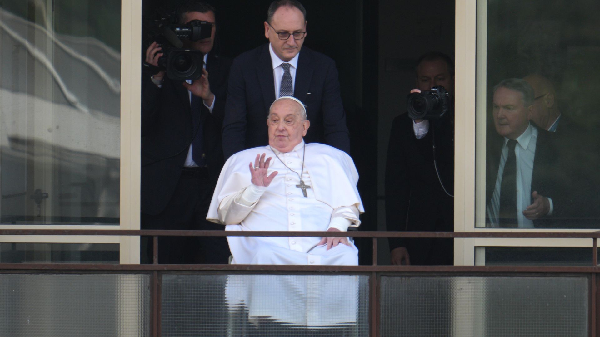 Pope Francis appears on his balcony to speak to the crowds at the Gemelli hospital, the first time he has appeared in public since being admitted to hospital on March 23, 2025 in Rome