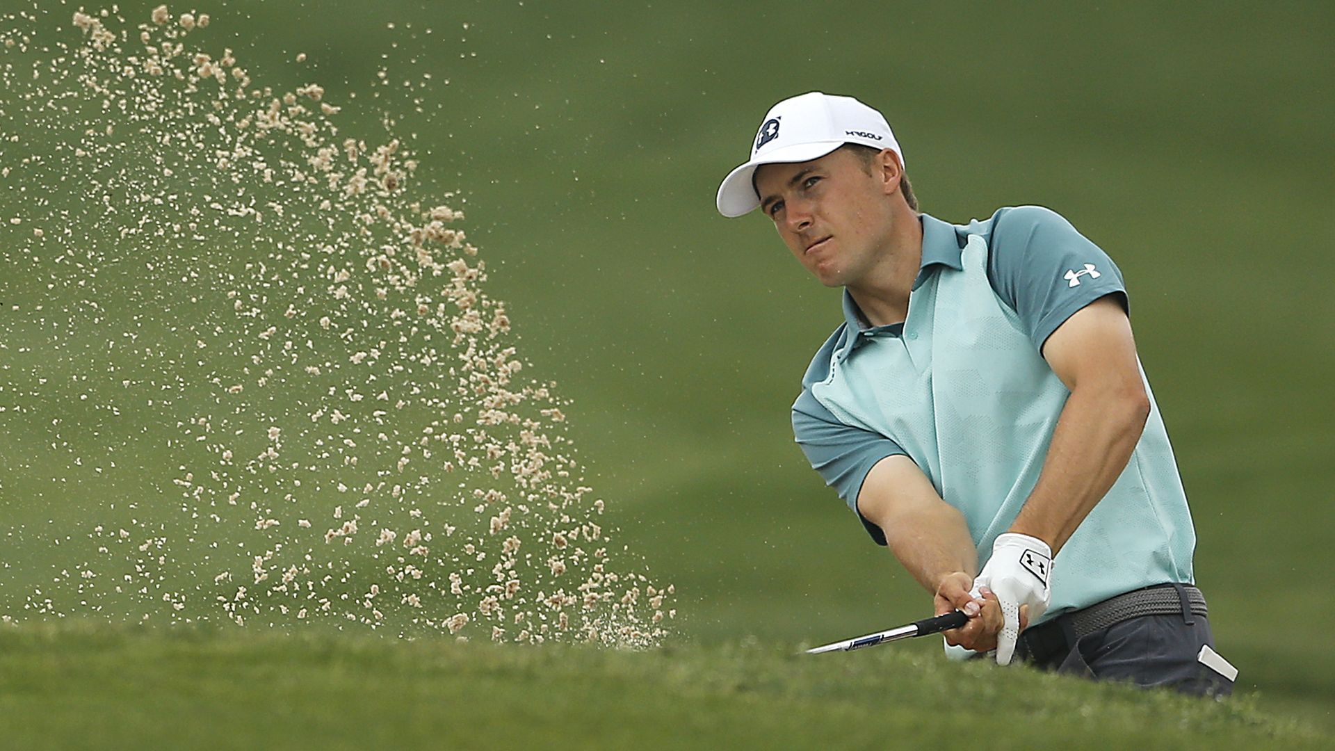 Jordan Spieth plays a shot from the bunker