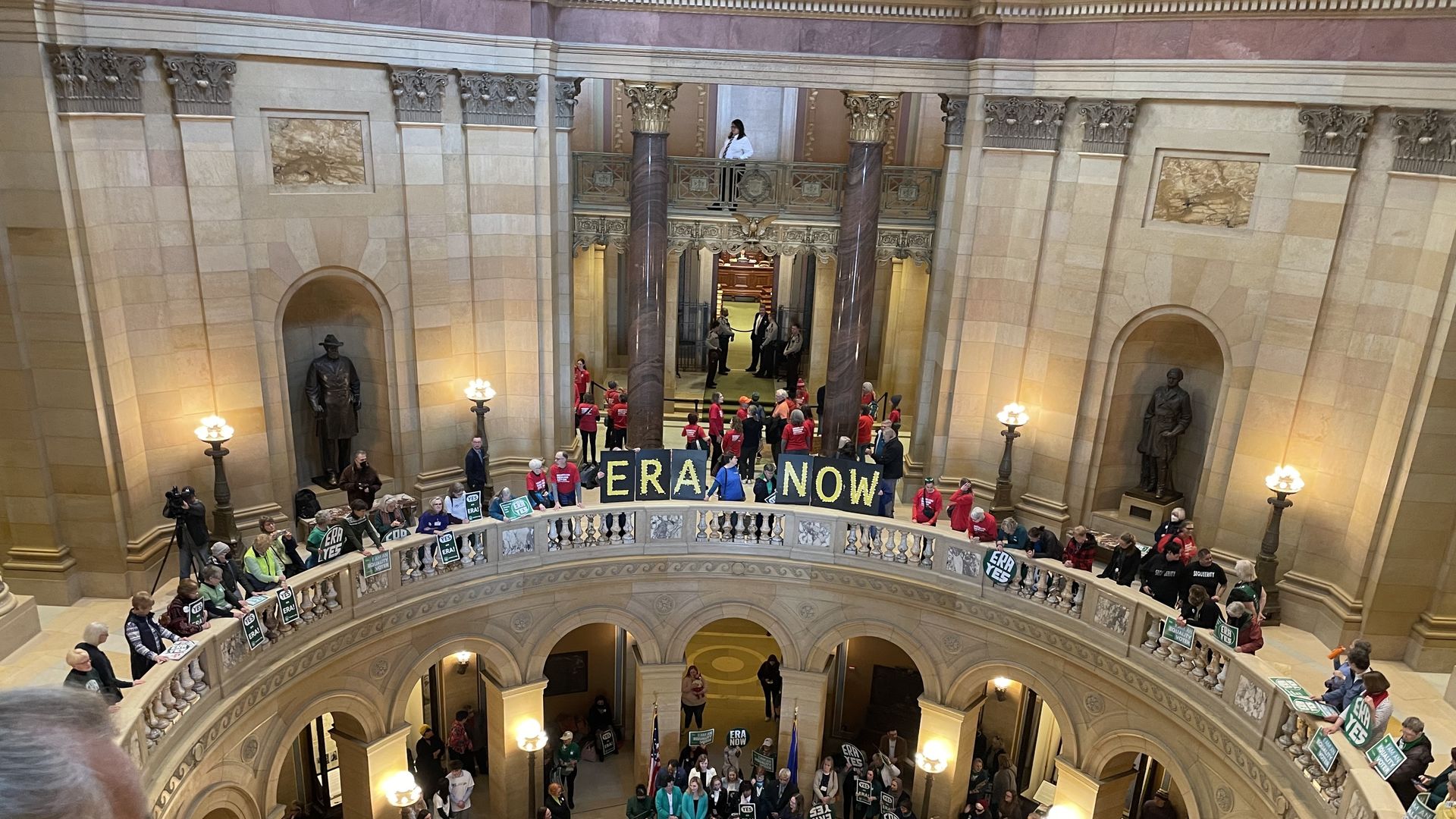 ERA supporters with a green sign outside the legislative chambers in minnesotra from above