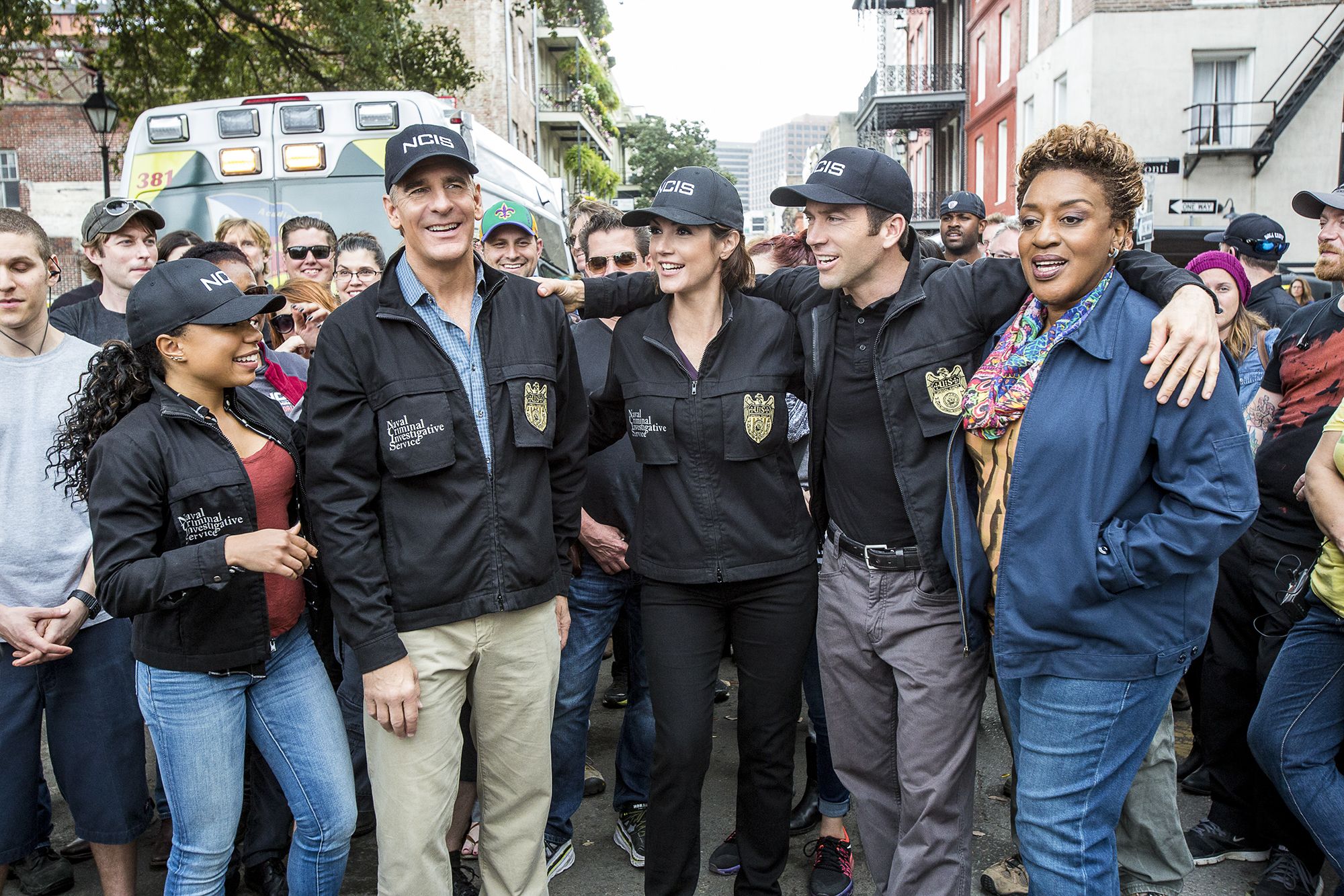 Image shows Shalita Grant, Scott Bakula, Zoe McLellan, Lucas Black, and CCH Pounder smiling in the French Quarter.