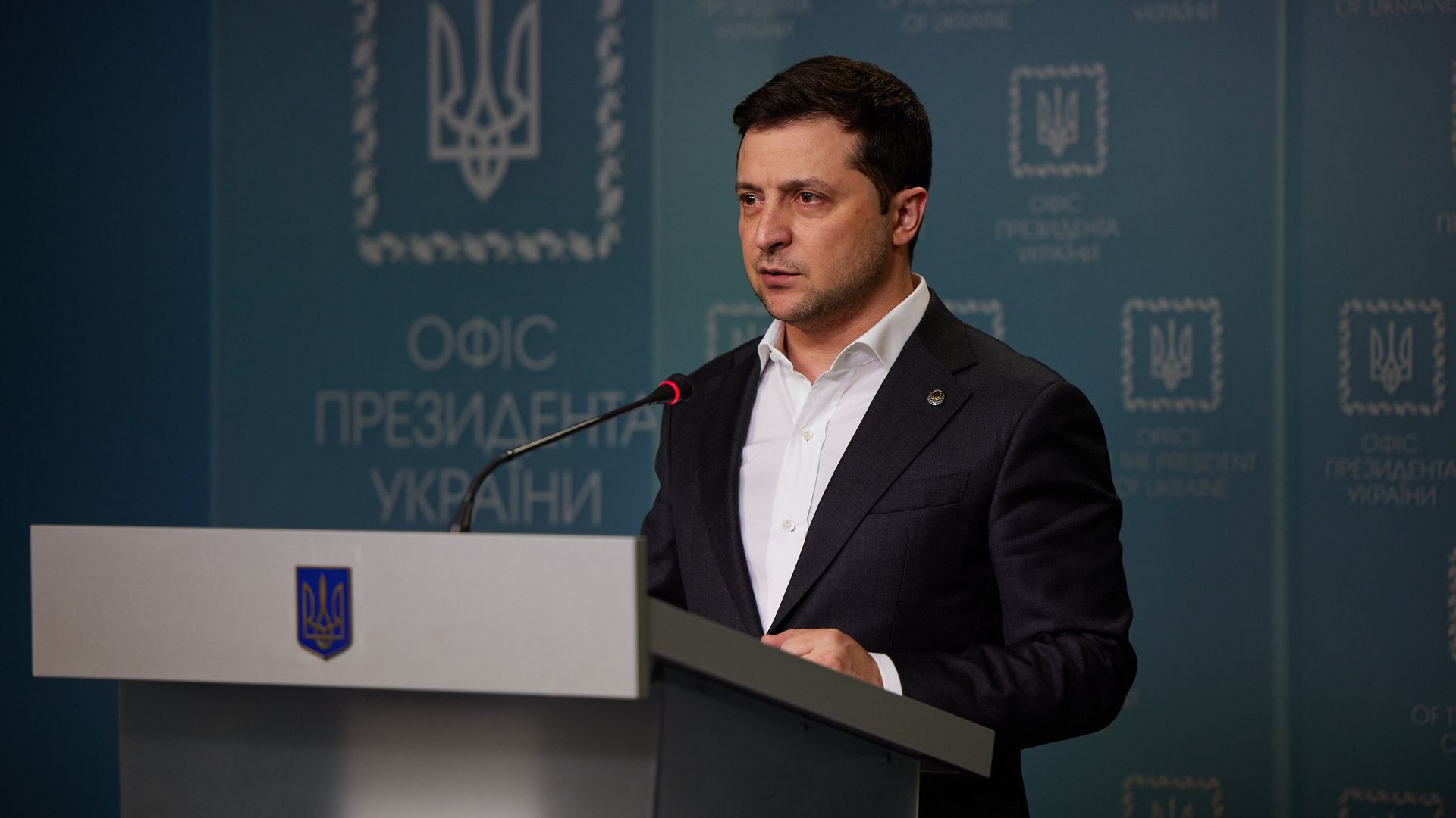Picture of Volodymyr Zelensky speaking behind a podium
