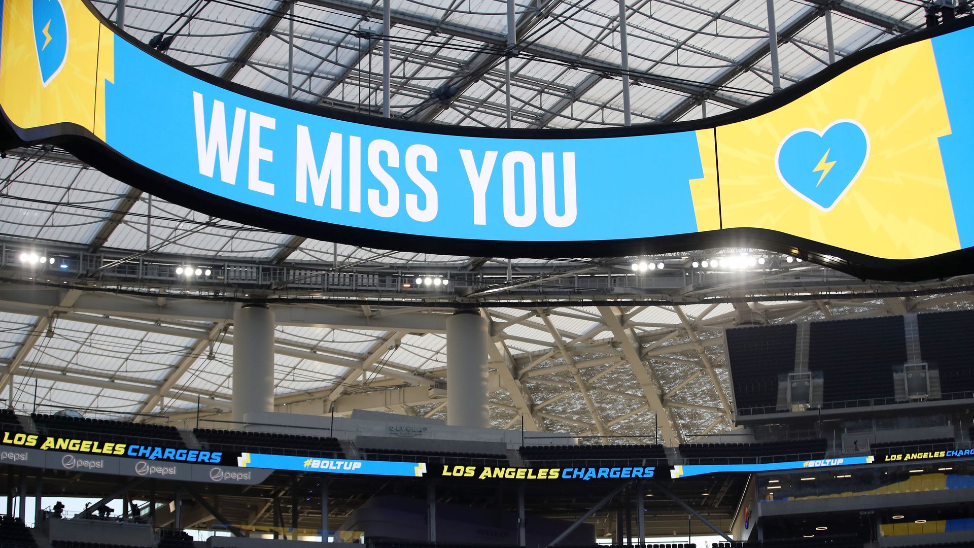chargers stadium with sign reading "we miss you"