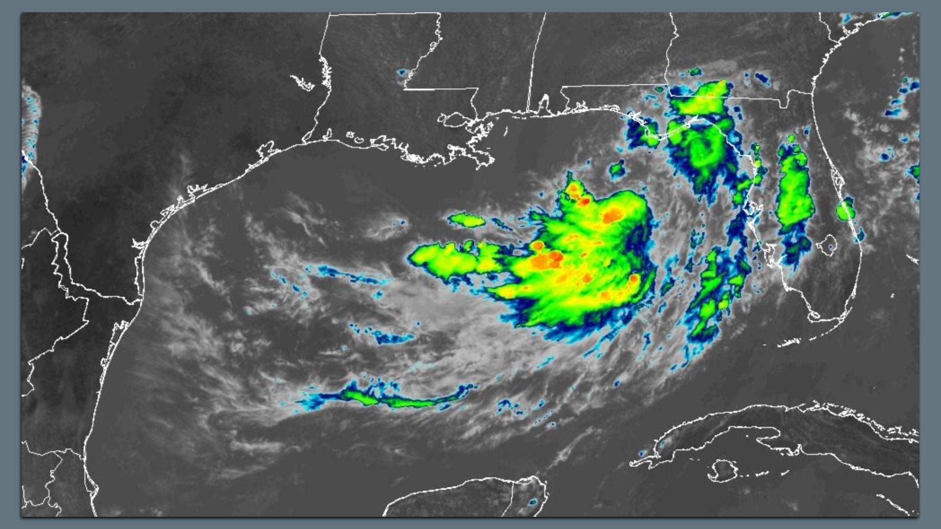 Satellite weather radar over the Gulf of Mexico showing a large storm cluster with bright green, yellow, and red echoes off Louisiana and the Florida Panhandle; state outlines appear in white.