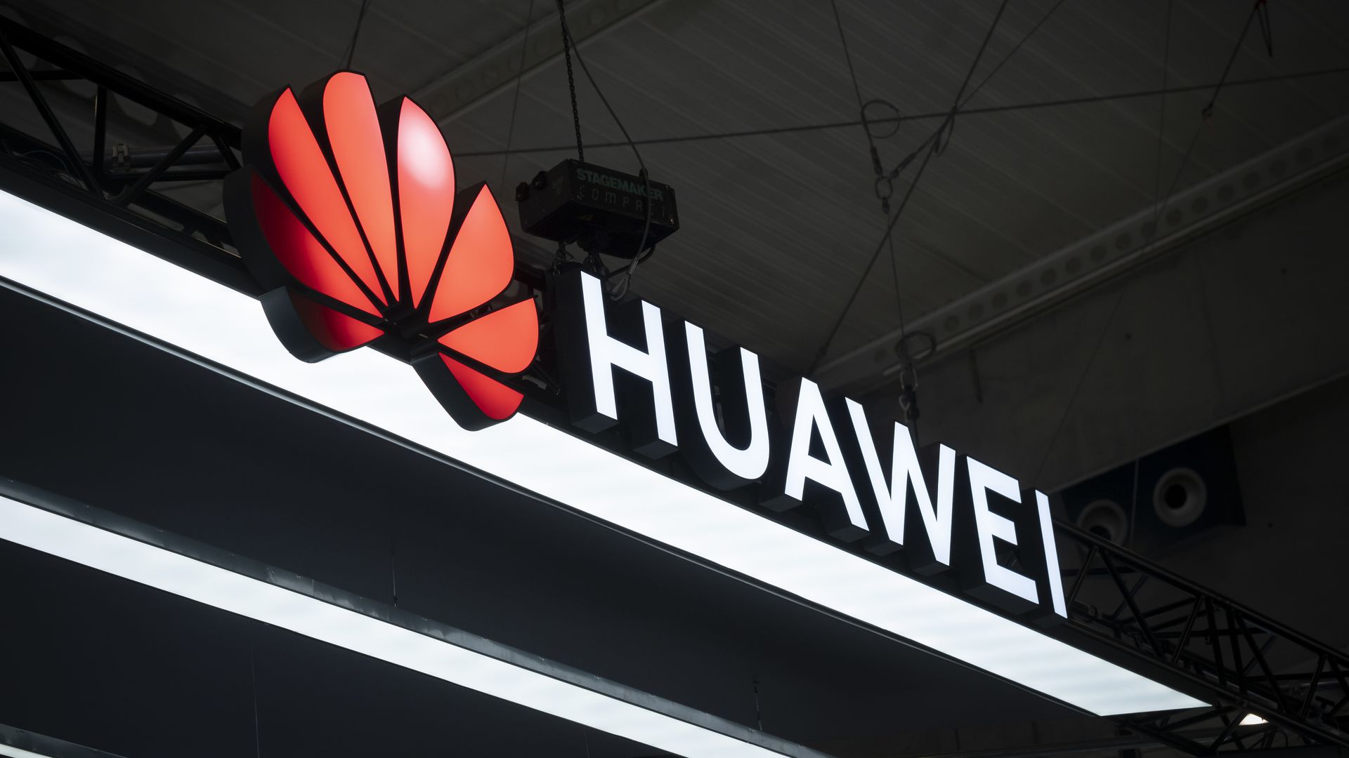 A photo of a sign with Huawei and its logo.
