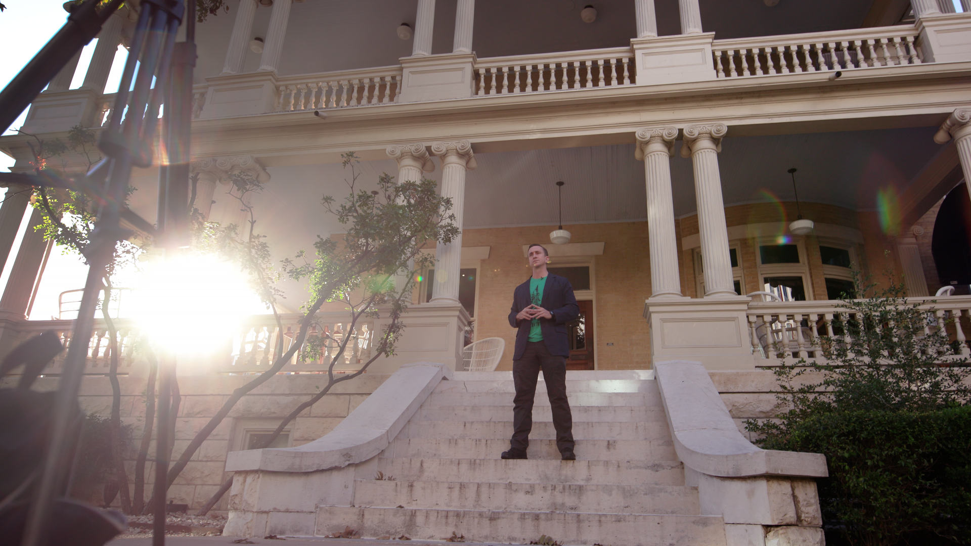 A photo of Peter Rex standing on the stairs of of Hotel Ella.
