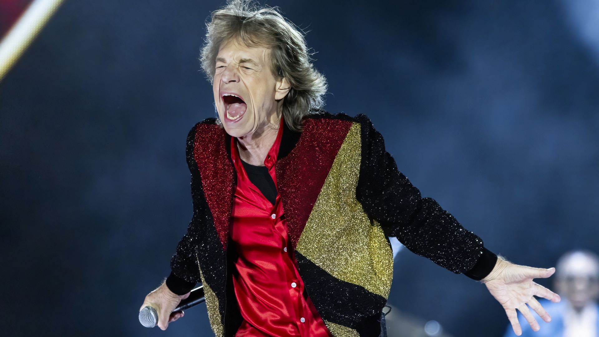 Mick Jagger shouts on stage.