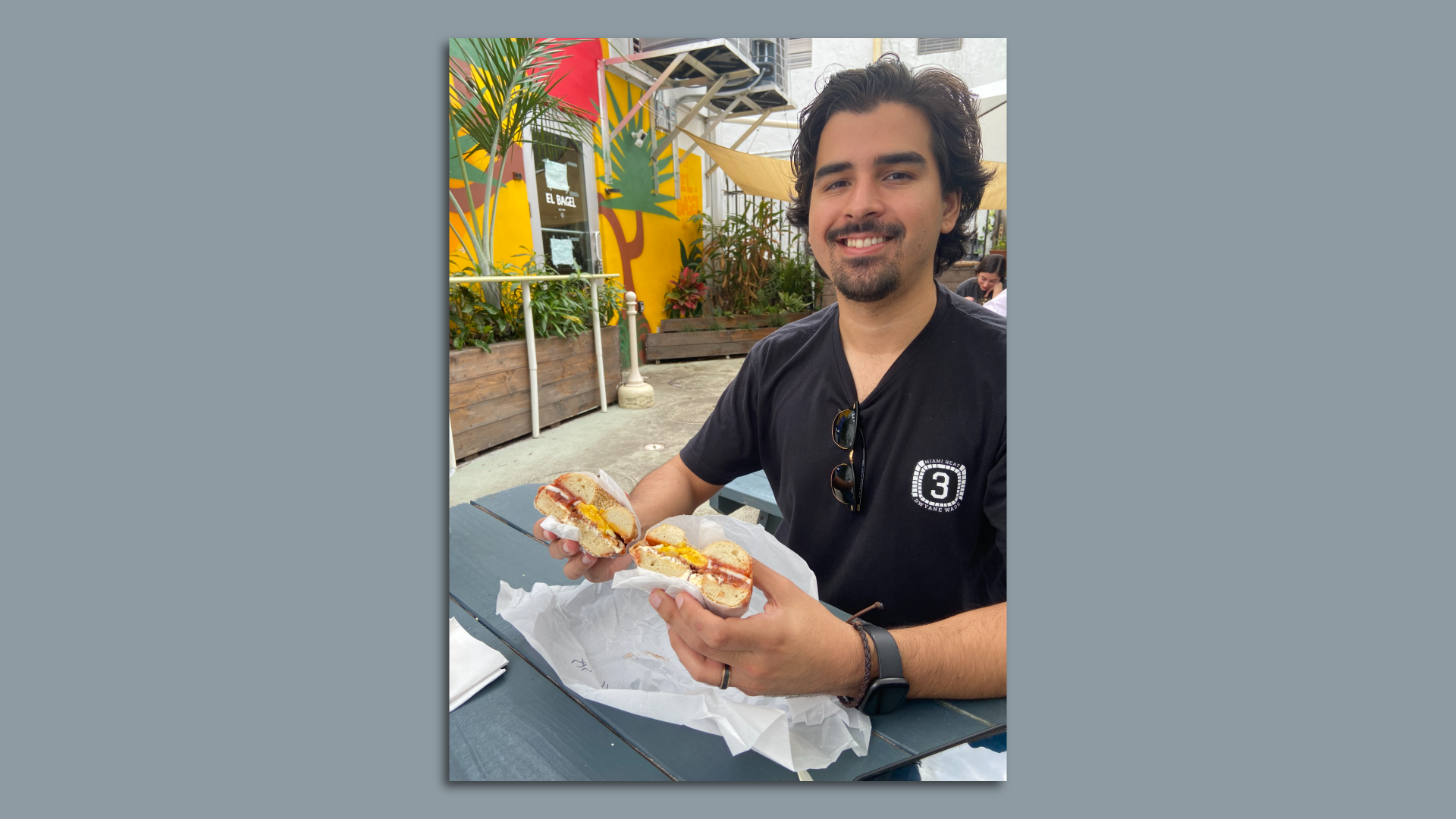Martin Vassolo posing with an El Bagel sandwich. 