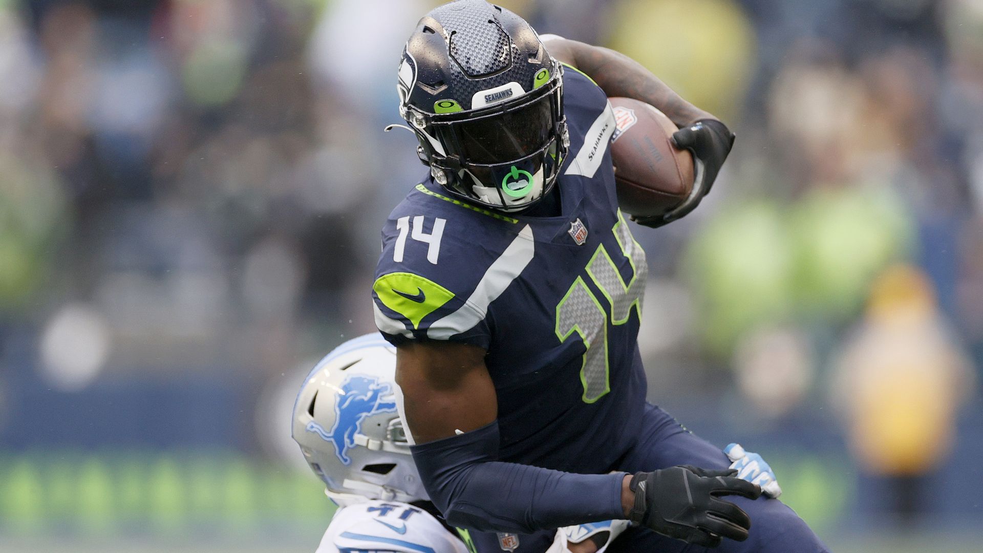 DK Metcalf #14 of the Seattle Seahawks carries the ball against the Detroit Lions during the first half at Lumen Field on January 02, 2022 in Seattle, Washington..