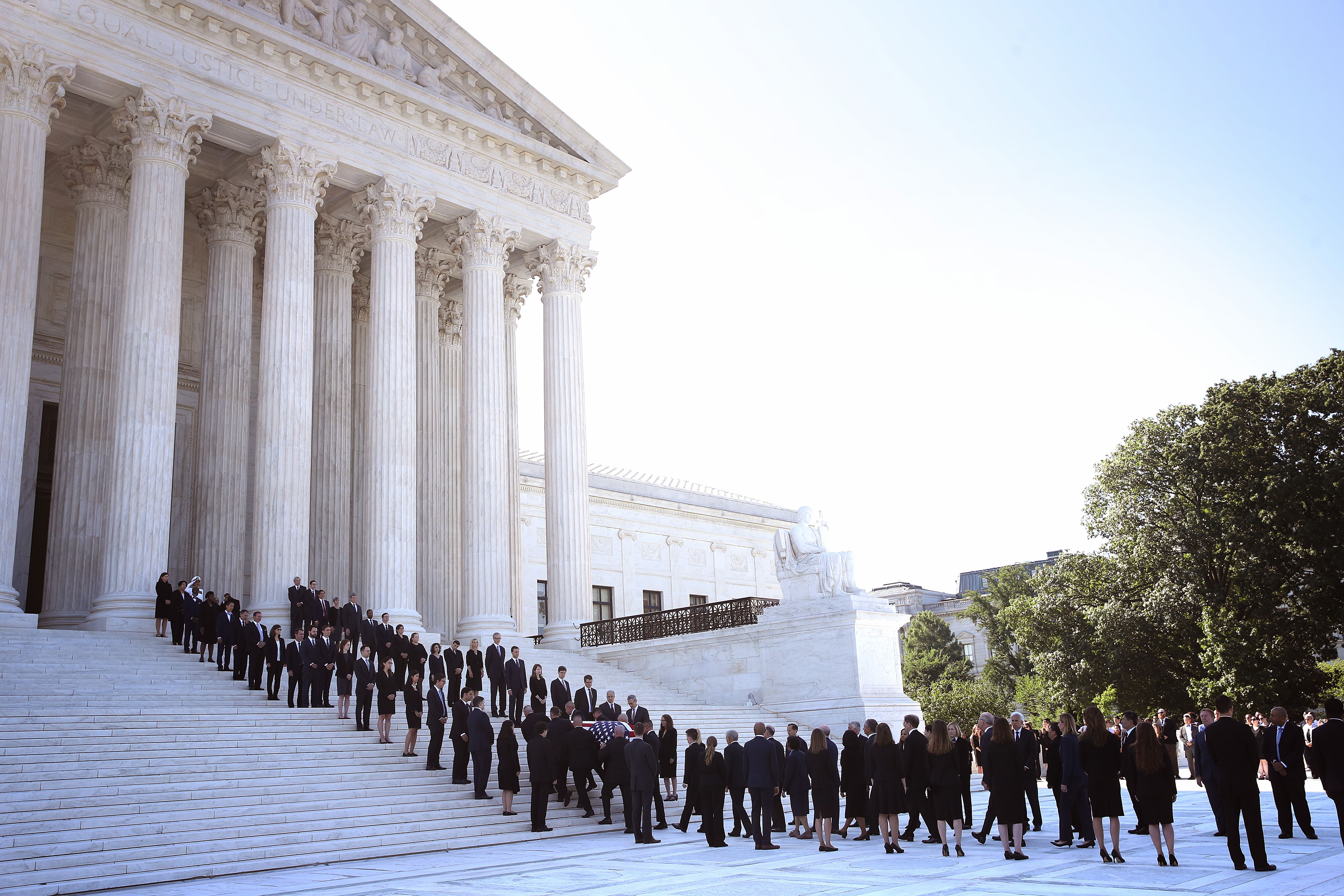 Members of the U.S. Supreme Court police serving as pallbearers carry the casket of the late Associate Justice John Paul Stevens up the steps of the U.S. Supreme Court 