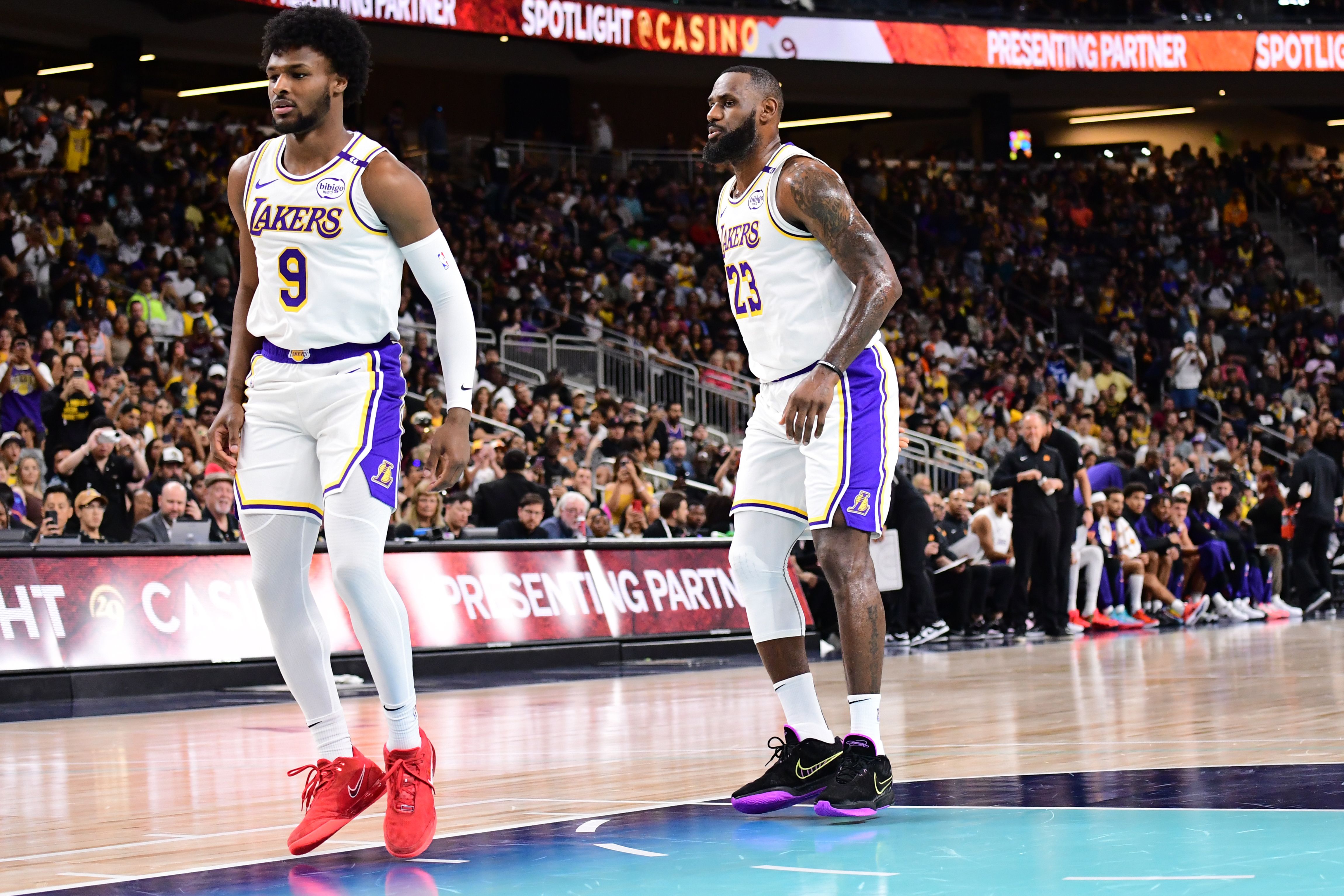 Bronny James #9 and LeBron James #23 of the Los Angeles Lakers look on during the game against the Phoenix Suns