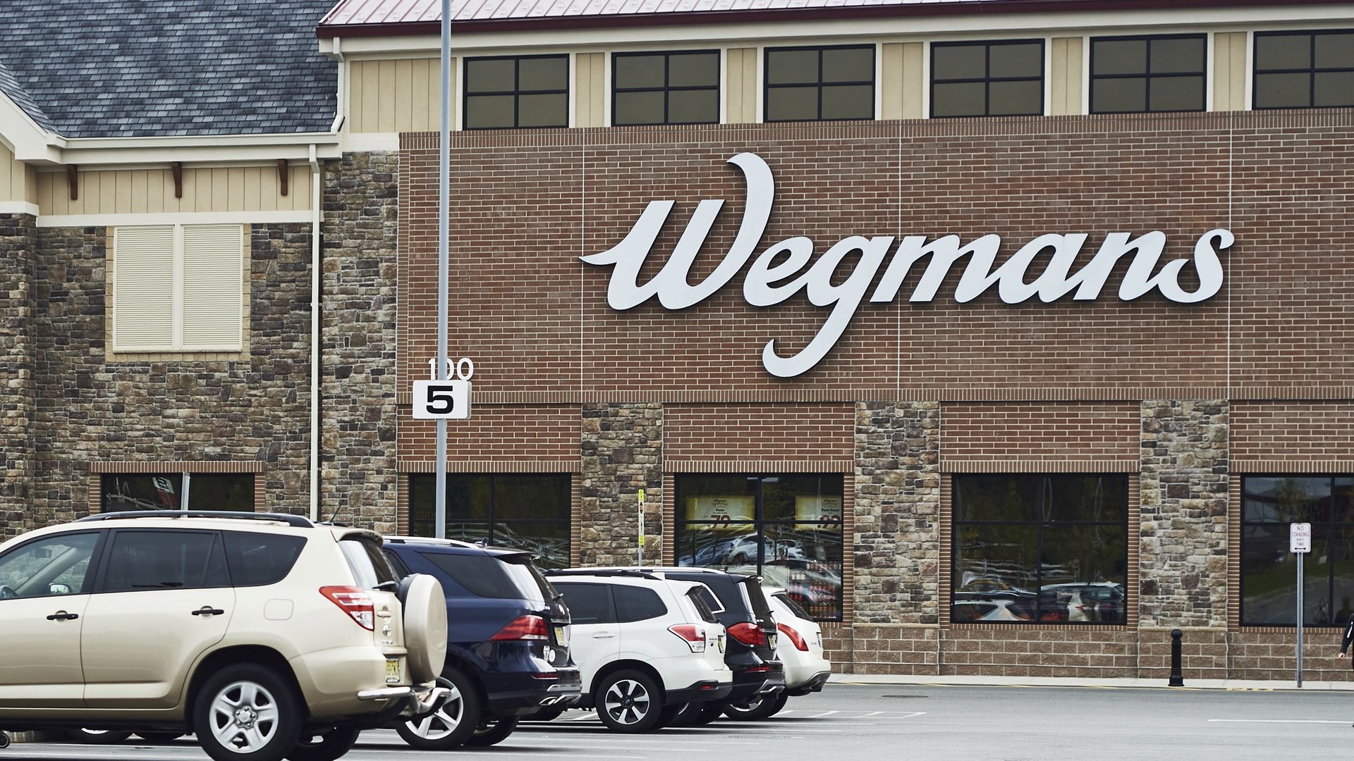 Vehicles sit parked outside of a Wegmans Food Markets Inc. supermarket in New Jersey in 2018.