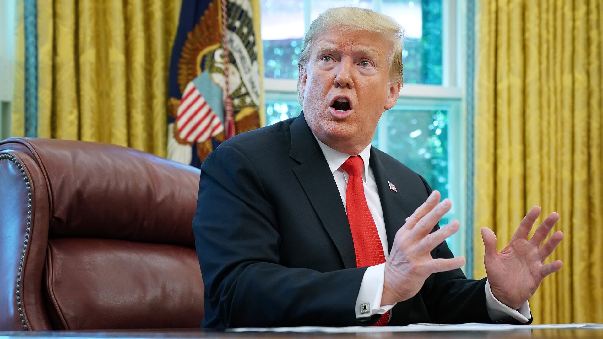 Trump sitting in the Oval Office.