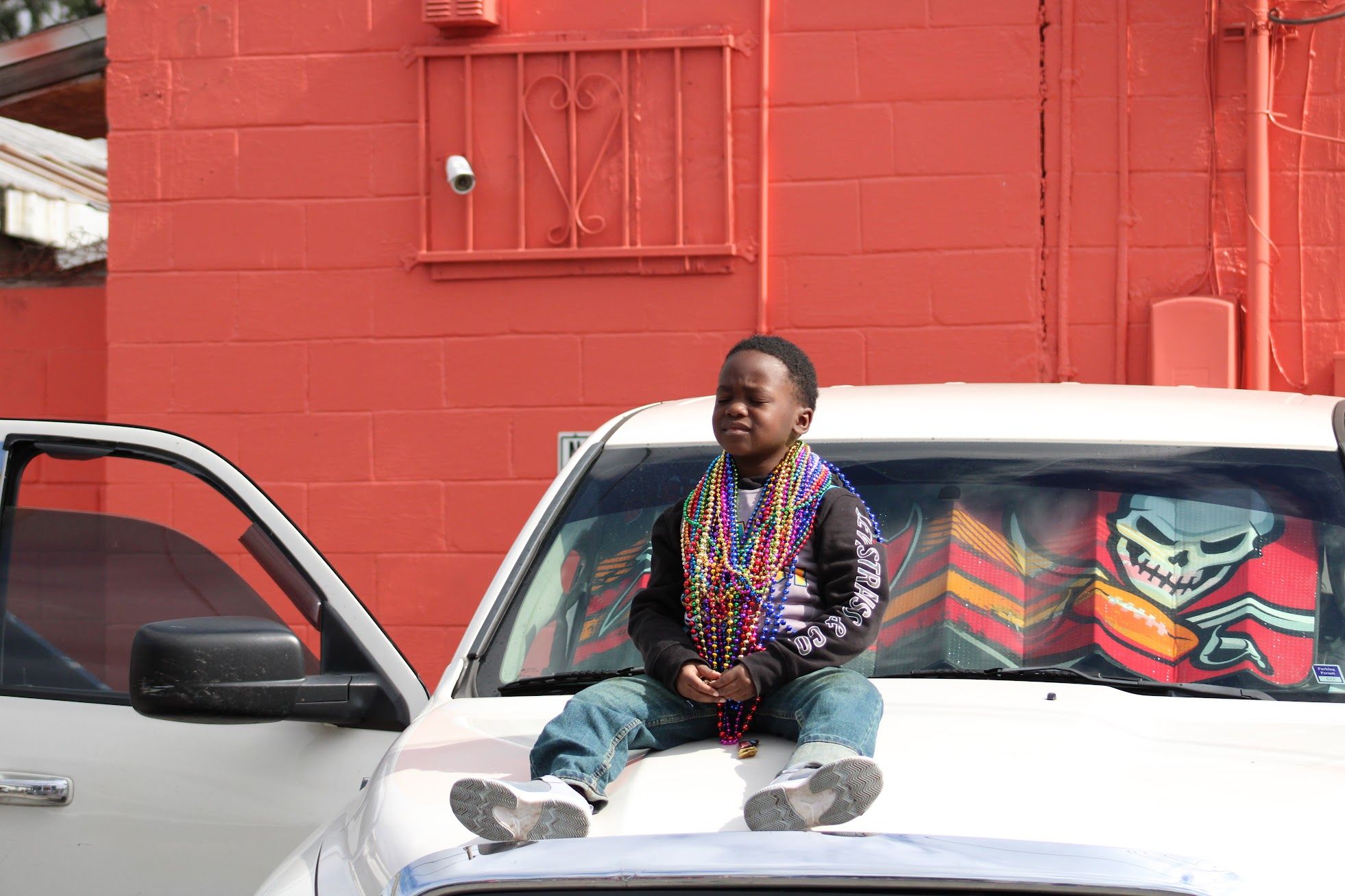 A boy sits on a car during Tampa's Martin Luther King Day Parade.