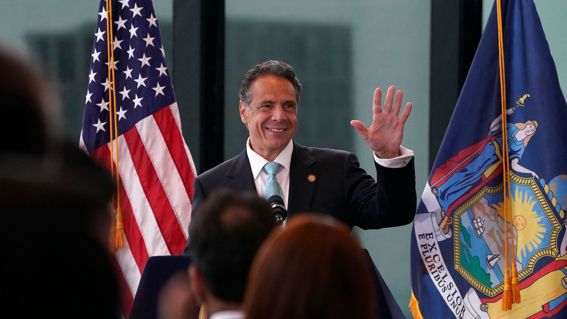 New York Governor Andrew Cuomo waves during an event to announce that New York will lift 'virtually all' Covid-19 restrictions.