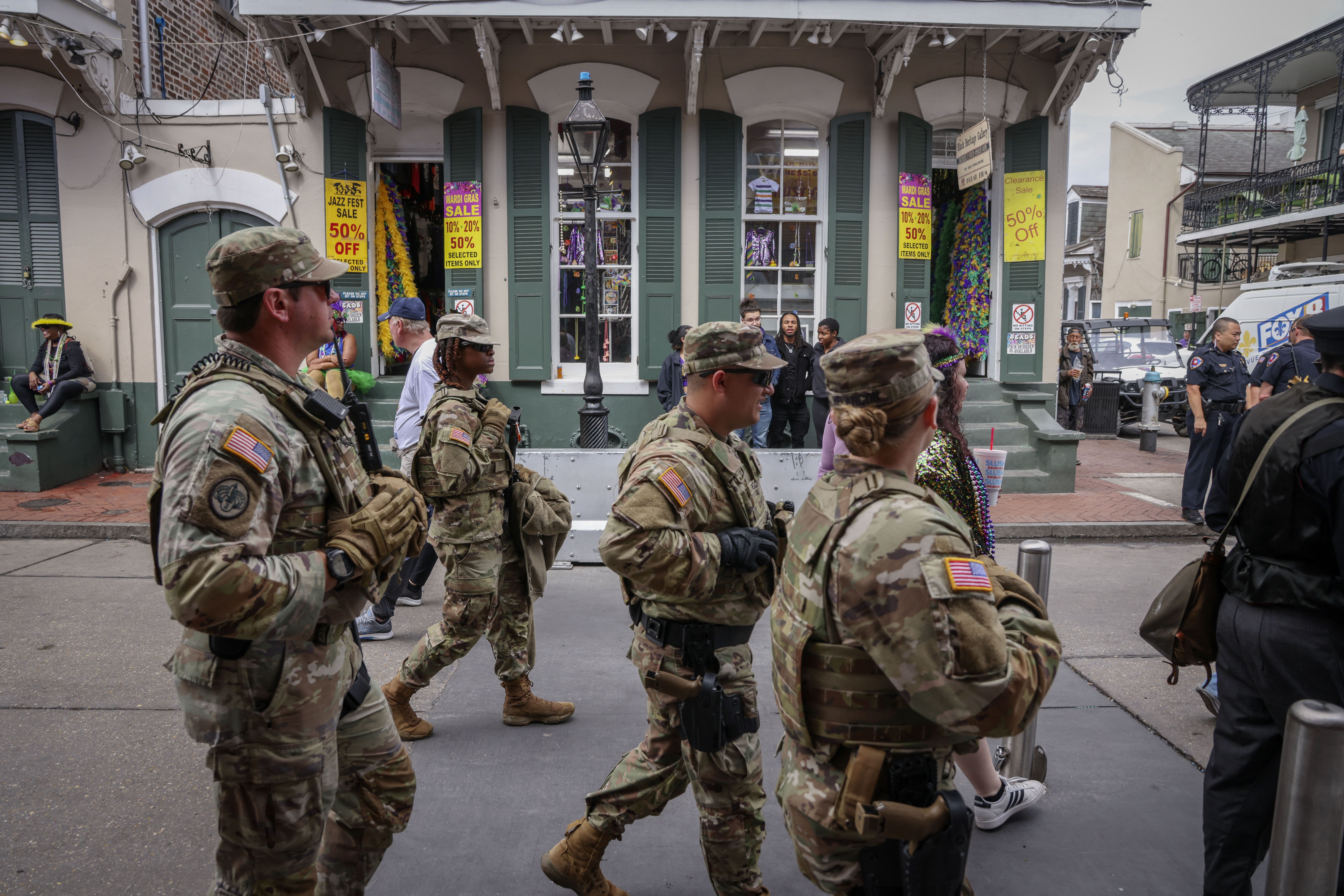 National Guard troops walk past a French Quarter souvenir shop.