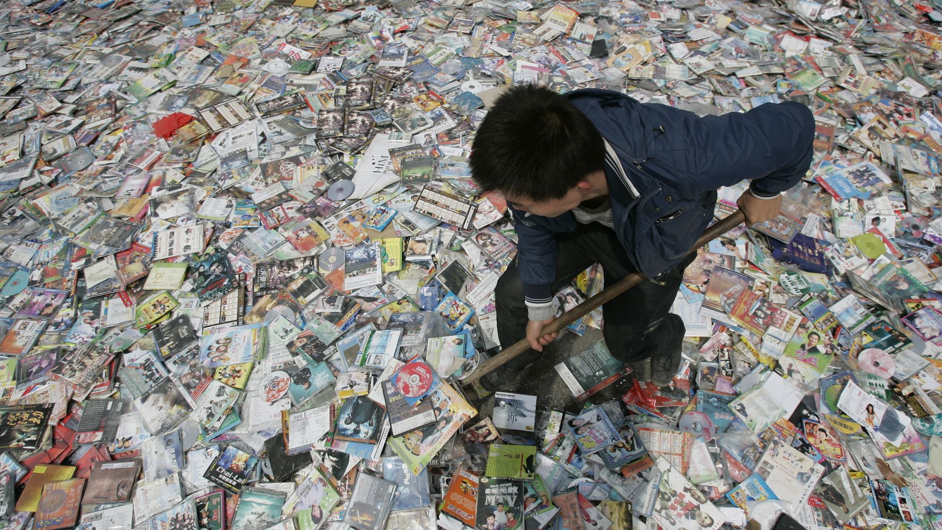 Worker prepares to destroy pirated CDs and DVDs in China