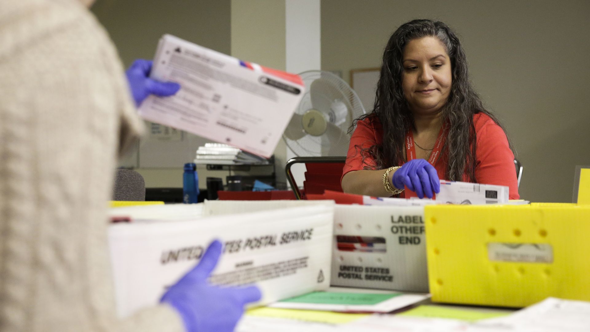 Ballot Processing Manager Jerelyn Hampton sorts vote-by-mail ballots by party for the presidential primary at King County Elections in Renton, Washington 