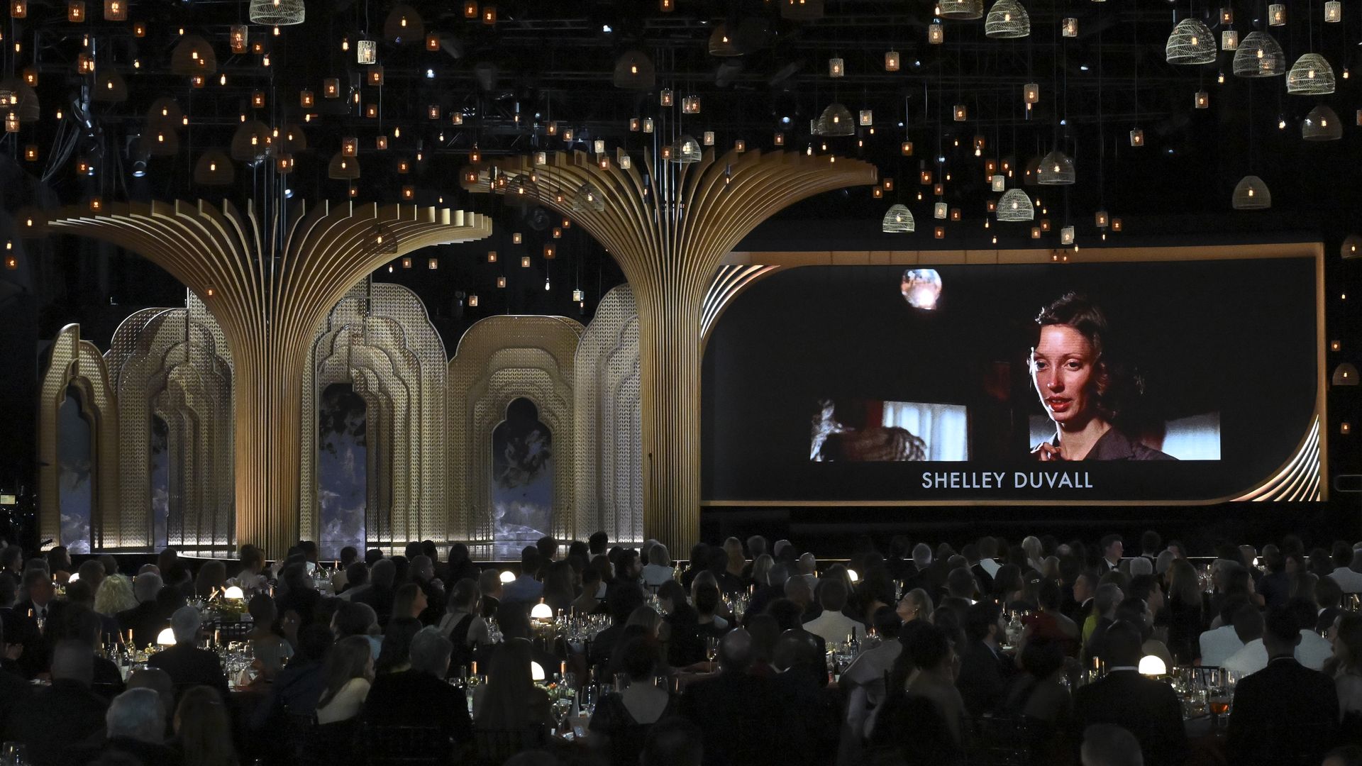 Shelley Duvall's image is displayed on a large screen at an awards show