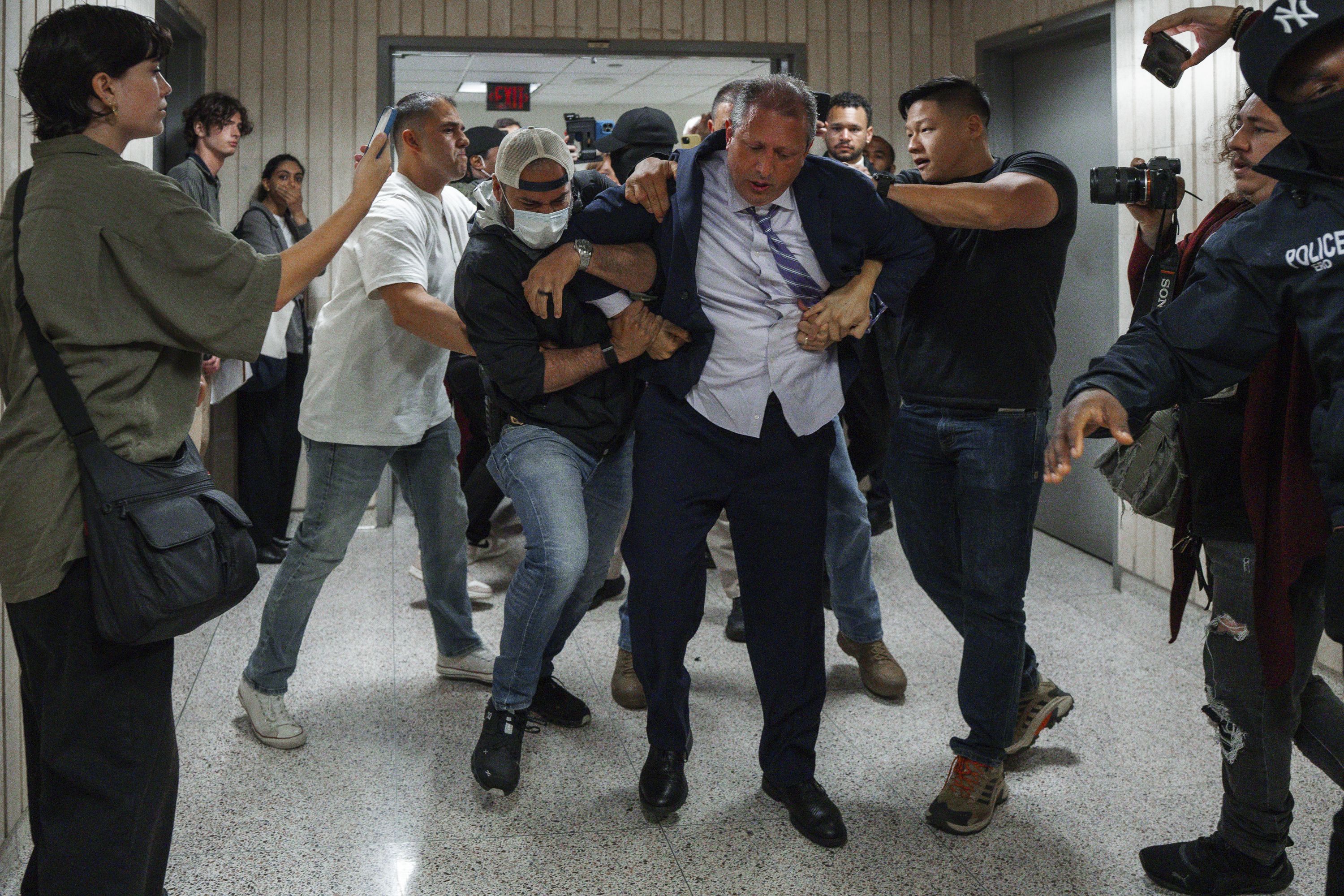New York City Comptroller Brad Lander is placed under arrest by Immigration and Customs Enforcement (ICE) and FBI agents outside federal immigration court on Tuesday, June 17, 2025, in New York. (AP Photo/Olga Fedorova)
