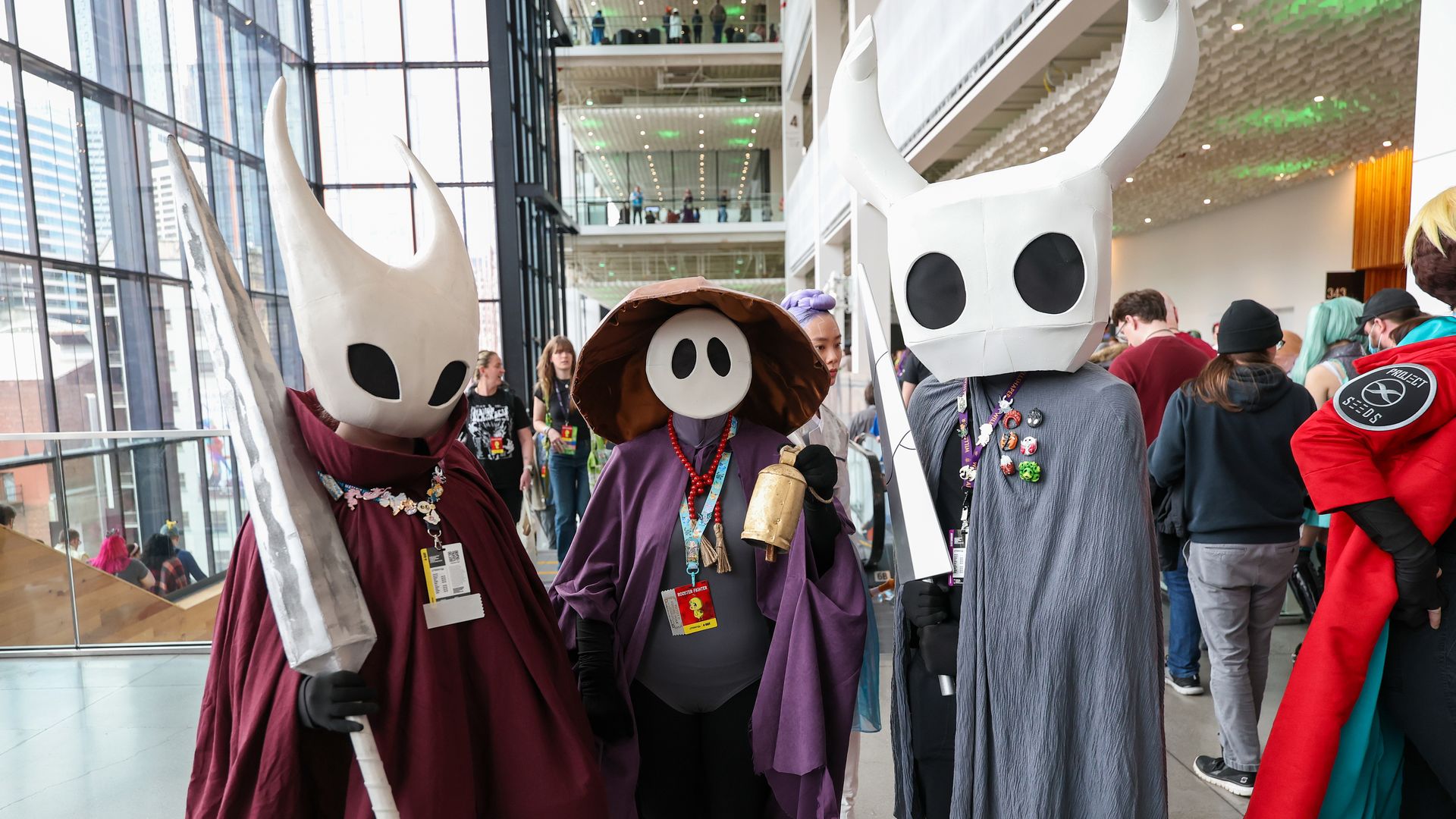 Cosplayers in alien-faced costumes at Emerald City Comic Con in Seattle.