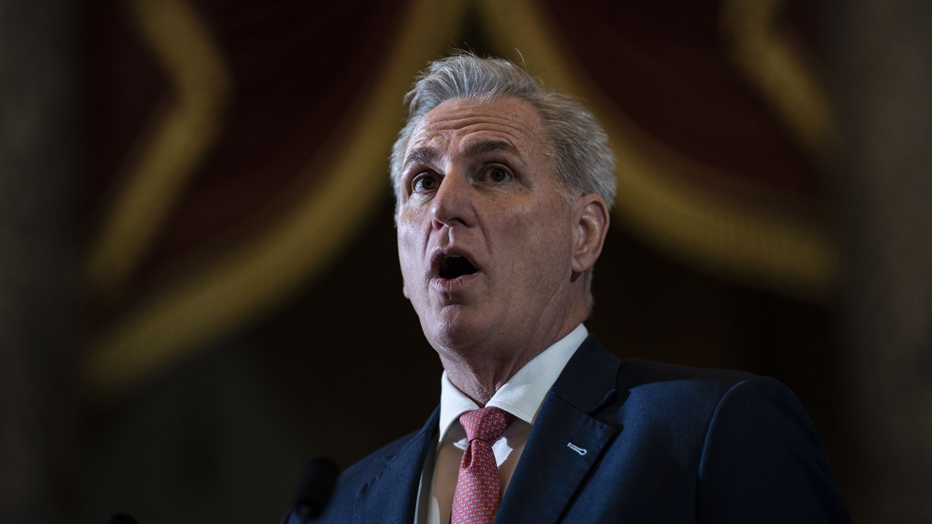 Kevin McCarthy, wearing a blue suit, white shirt and pink tie.