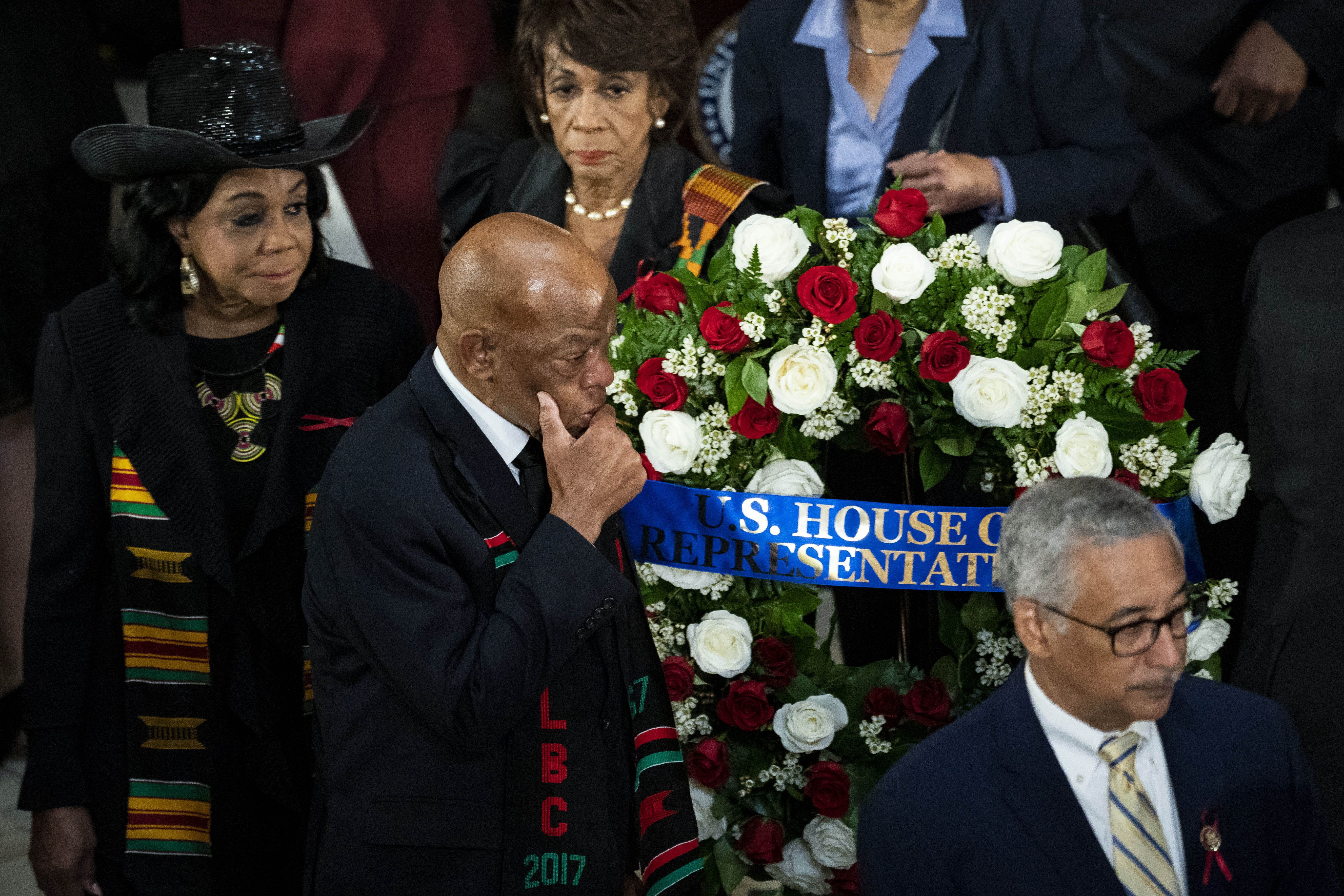 Representative John Lewis stands next to Elijah Cummings' casket.