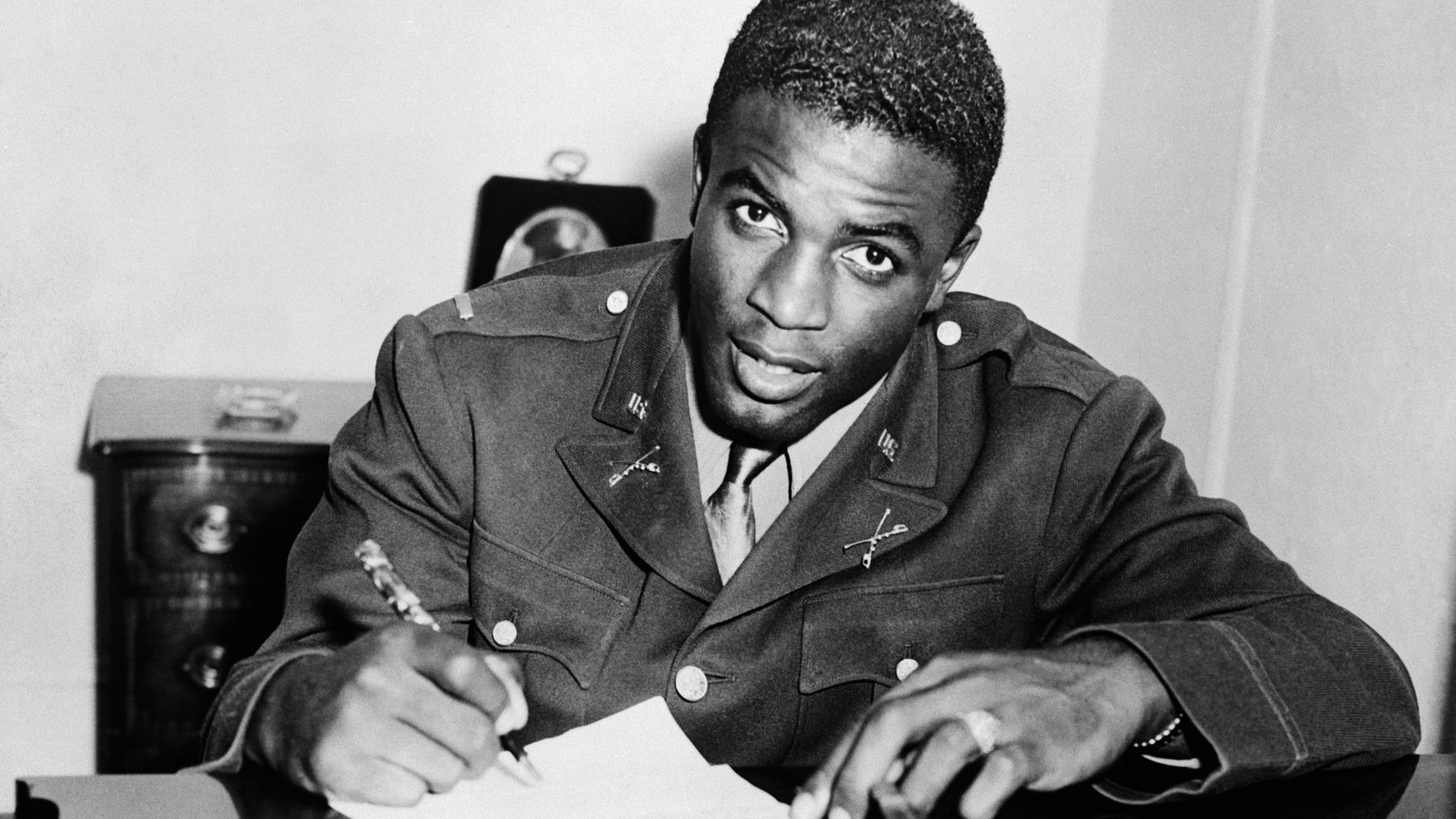 Jackie Robinson, in military uniform, becomes the first African American to sign with a white professional baseball team. He signs a contract with the minor league club in Montreal, a farm team for the Brooklyn Dodgers.