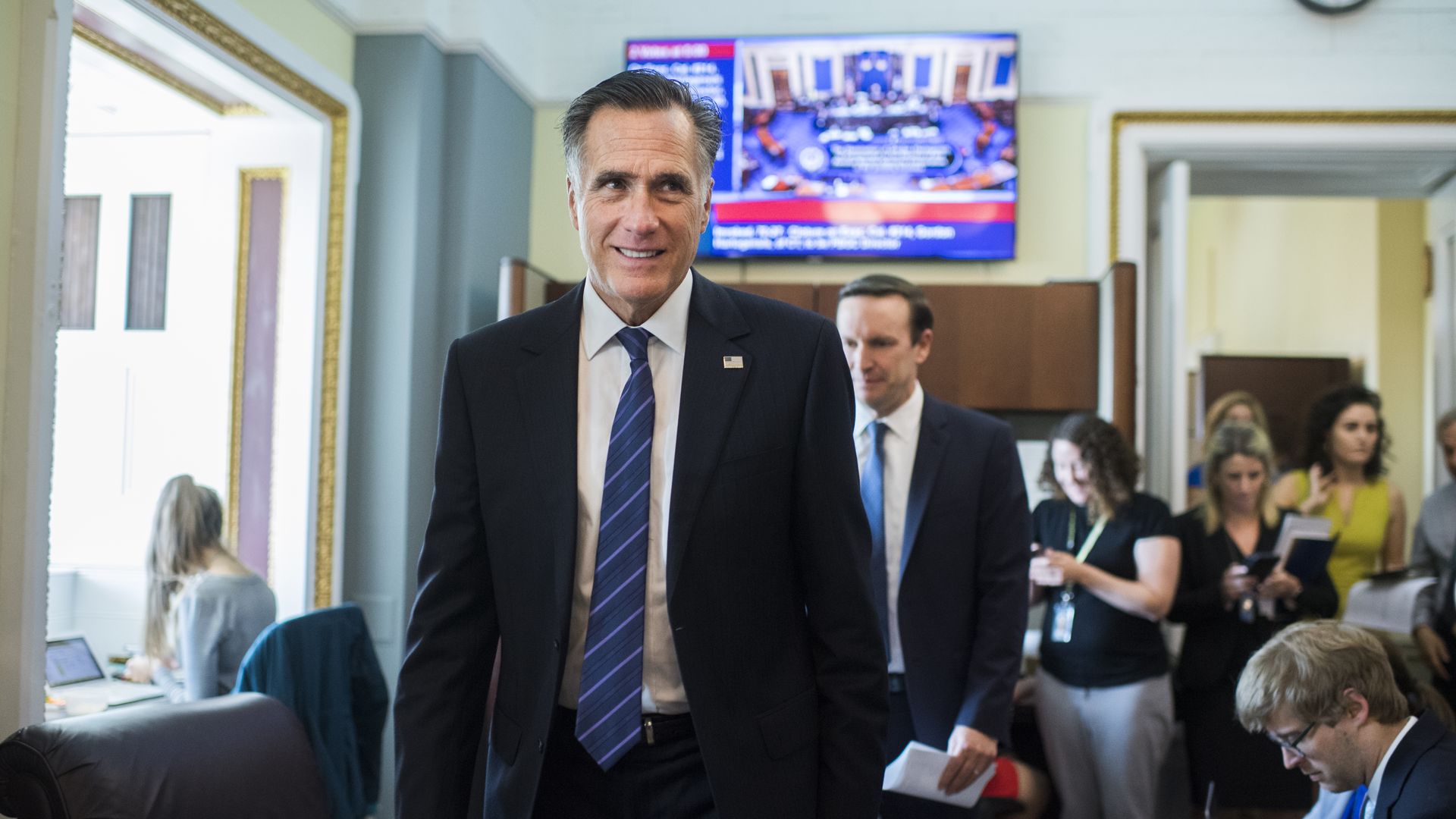 Sens. Mitt Romney and Chris Murphy in the Capitol building in 2019.